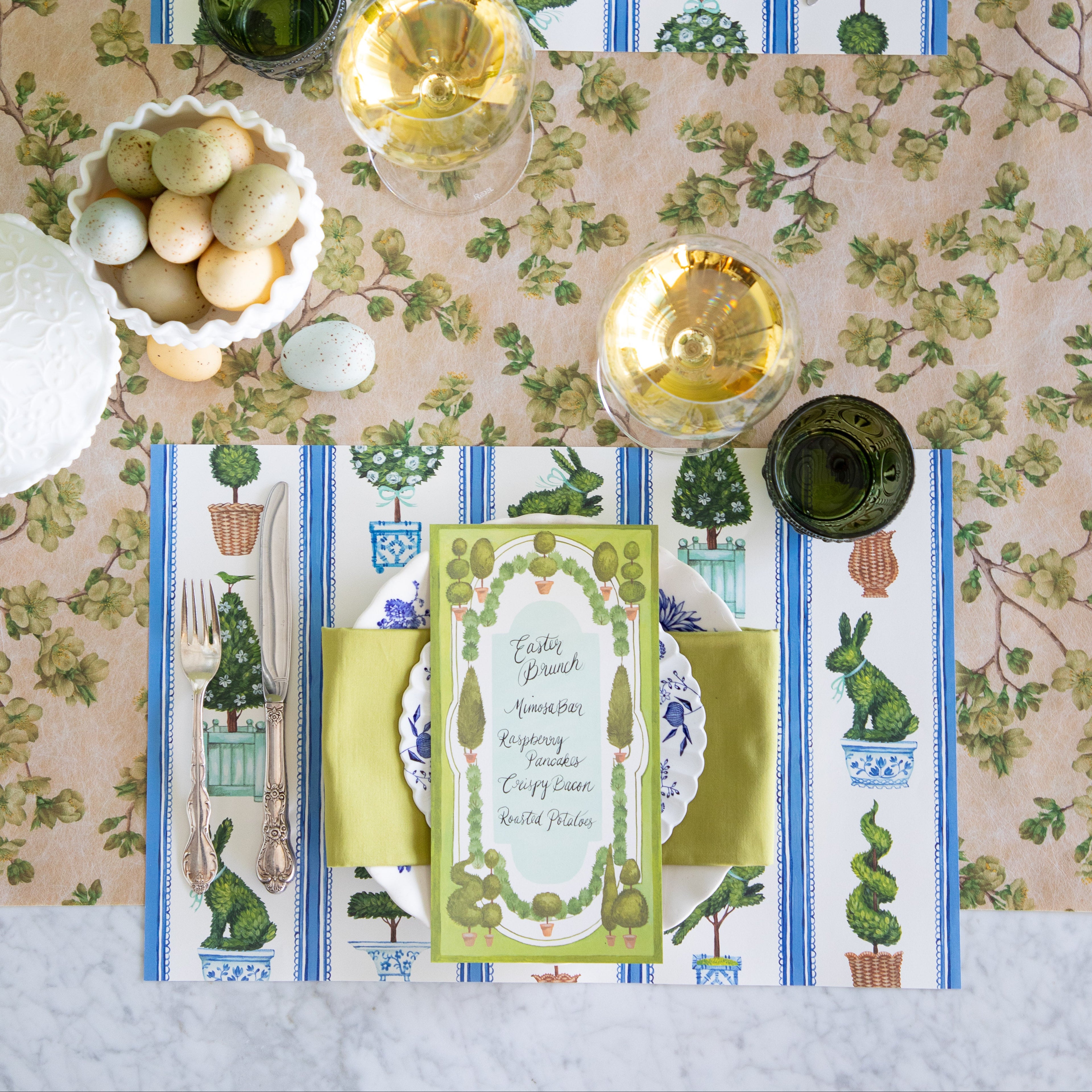 Easter table setting with eggs, Spring Topiary Placemat, Topiary Garden Table Card, floral plates and green napkin on the Green Cherry Blossom Runner.
