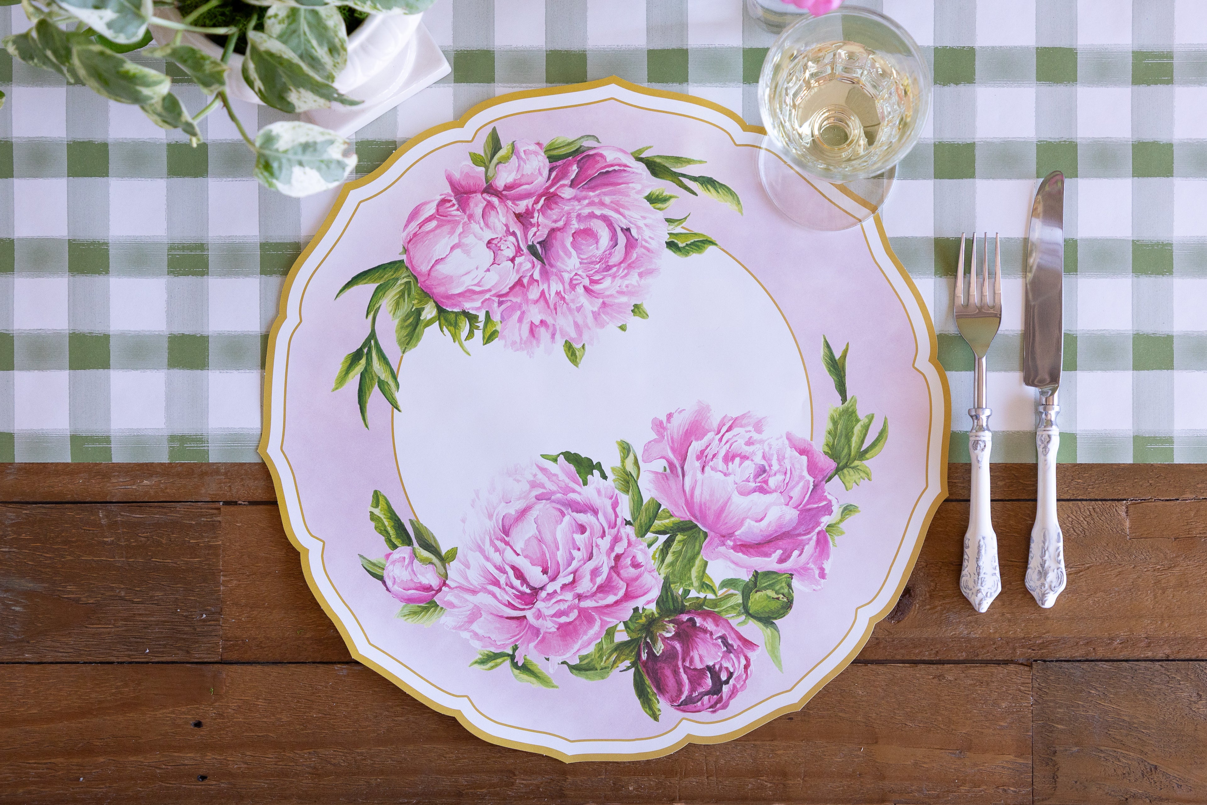 Die-cut Peony China Placemat, vintage cutlery and glass of wine on the Moss Painted Check Runner.