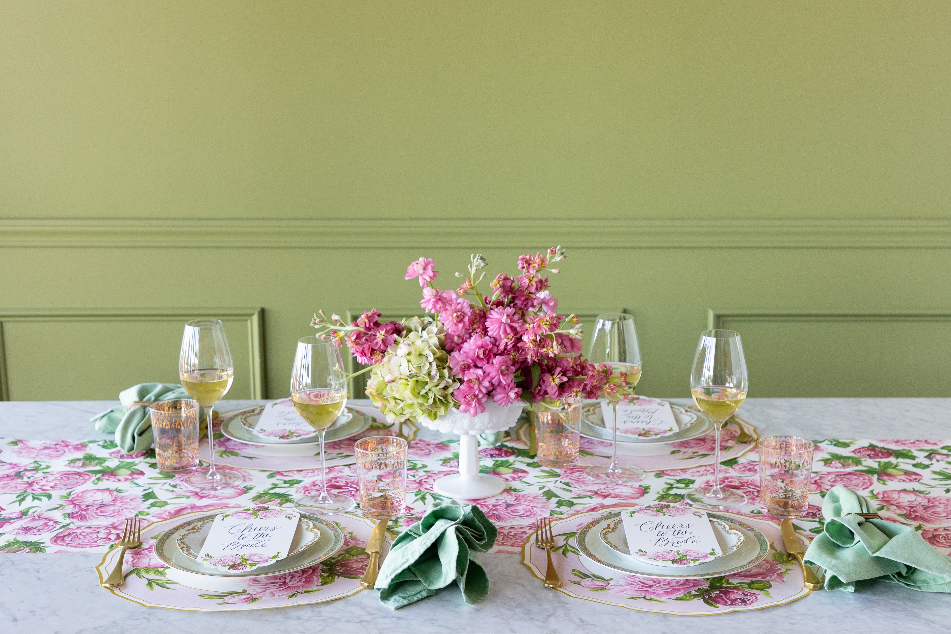 Decorative table setting with Die-cut Peony China Placemats, green rimmed and pink floral plates, vintage cutlery and flowers on the Peonies in Bloom Runner.