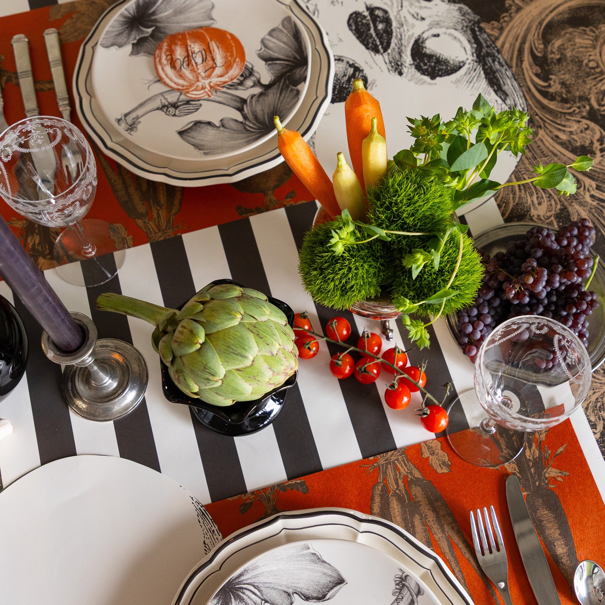Elegant table setting with Harvest Vegetable Persimmon Placemats, decorative plates, and fresh vegetables on the Black Classic Stripe Runner.