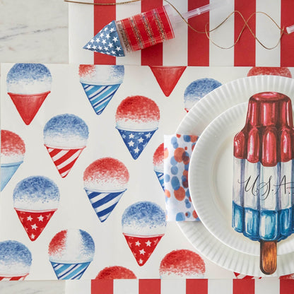 Close-up of a Snow Cone Placemat under a patriotic place setting, from above.