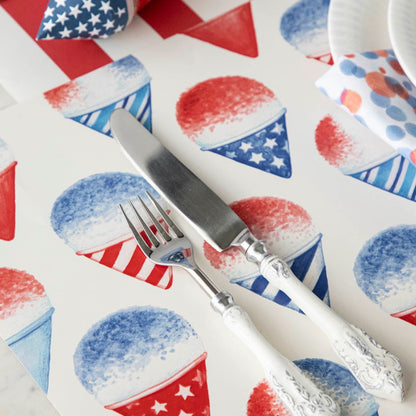 Close-up of a Snow Cone Placemat under a patriotic place setting, showing the artwork in detail.