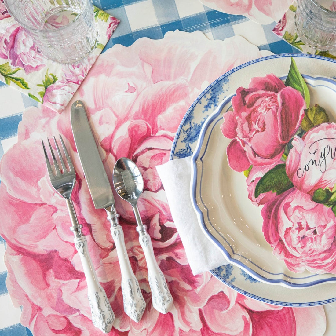 The Die-cut Peony Placemat under an elegant floral place setting.