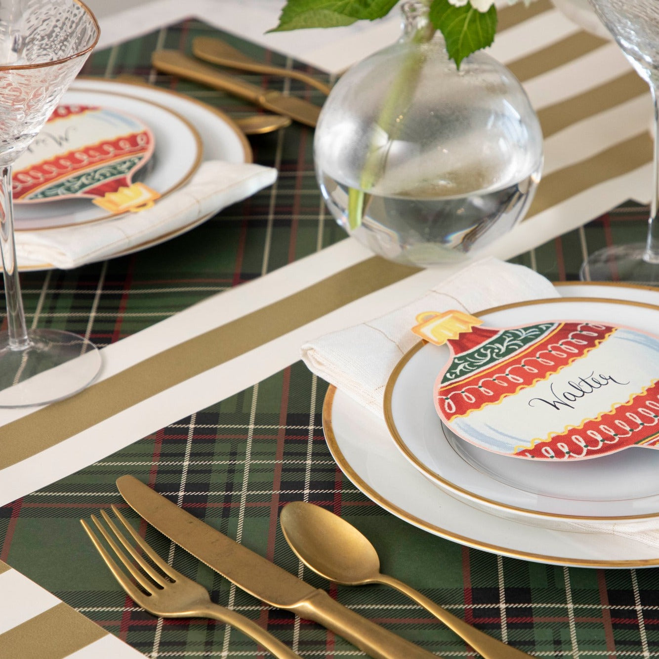Close-up of the Green Plaid Placemat under a festive holiday-themed table setting for two.