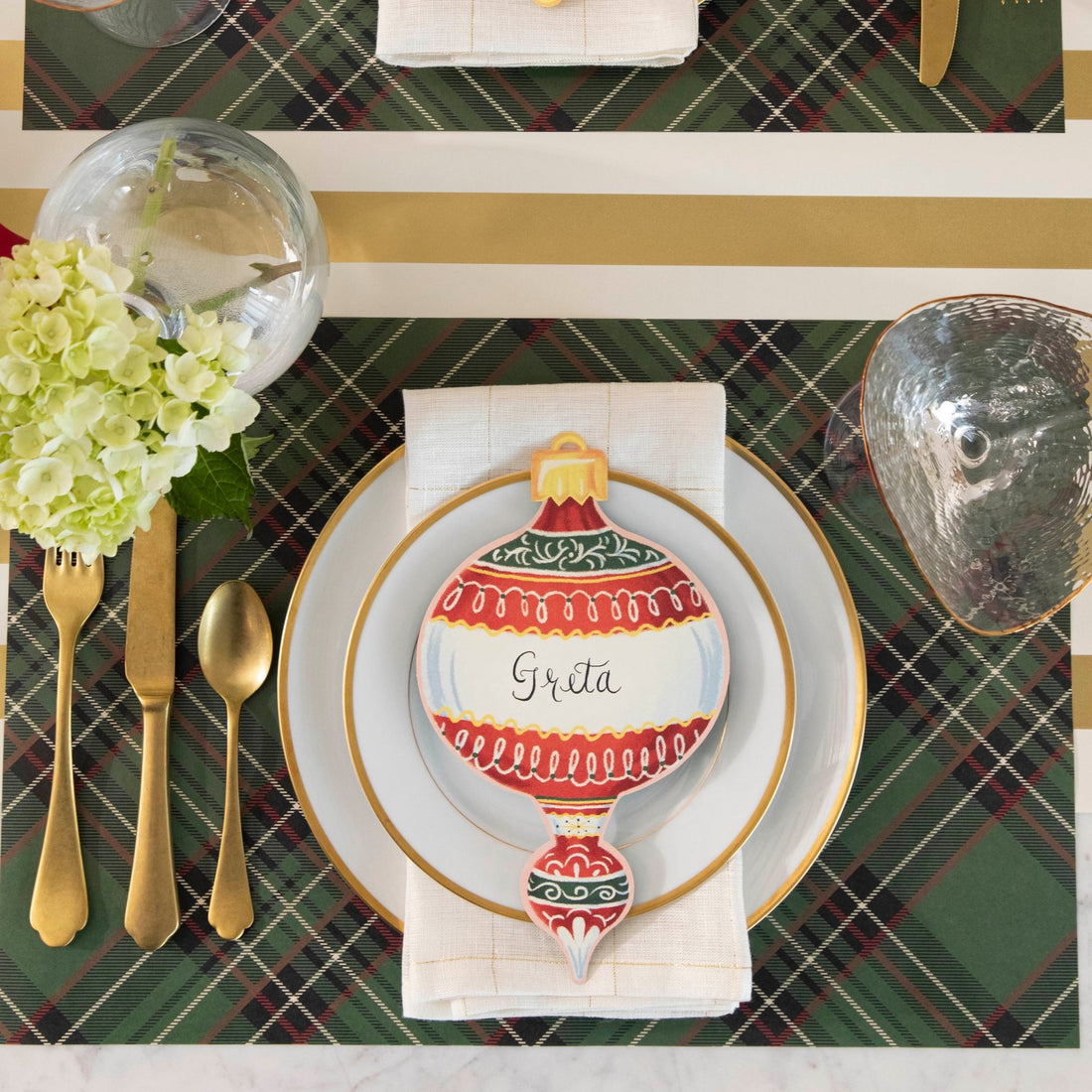 The Green Plaid Placemat under a festive holiday-themed place setting, from above.