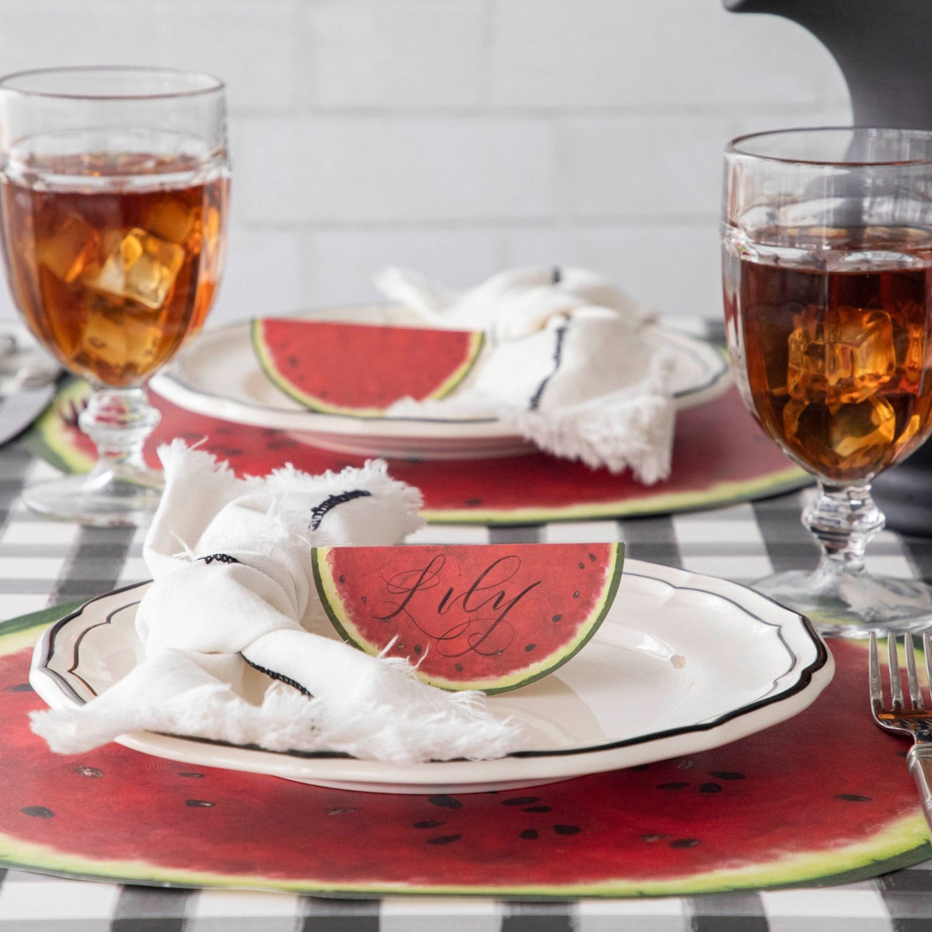 An elegant summertime table setting featuring Watermelon Place Cards standing on the plates.