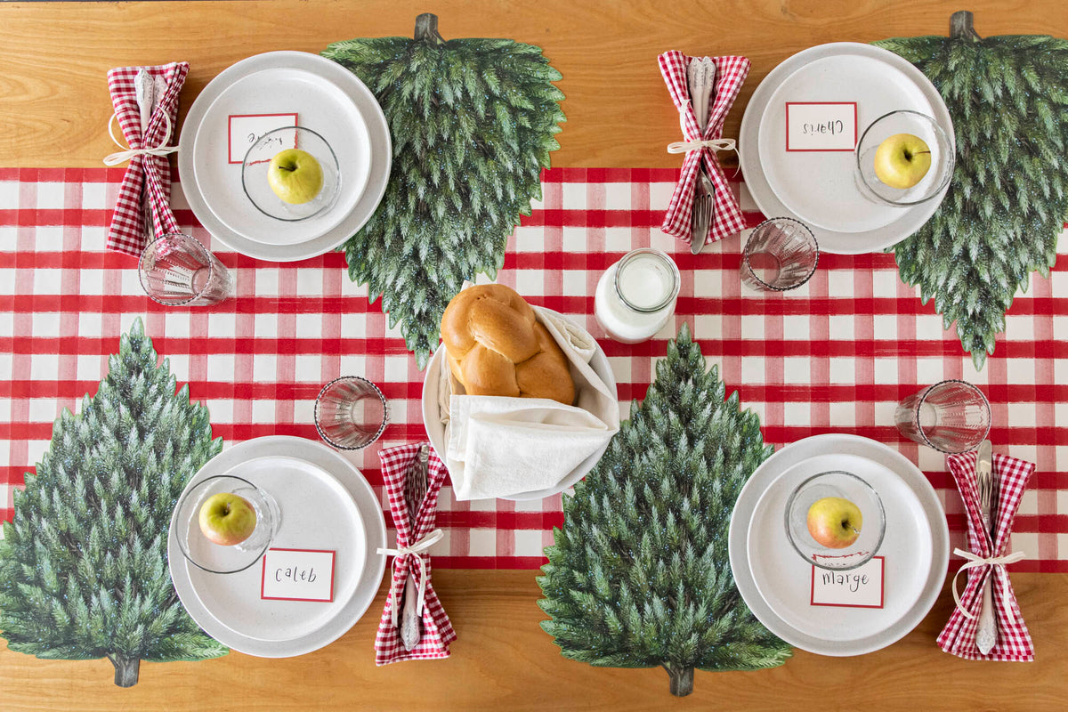 The Die-cut Evergreen Placemat under a rustic table setting for four, from above. 