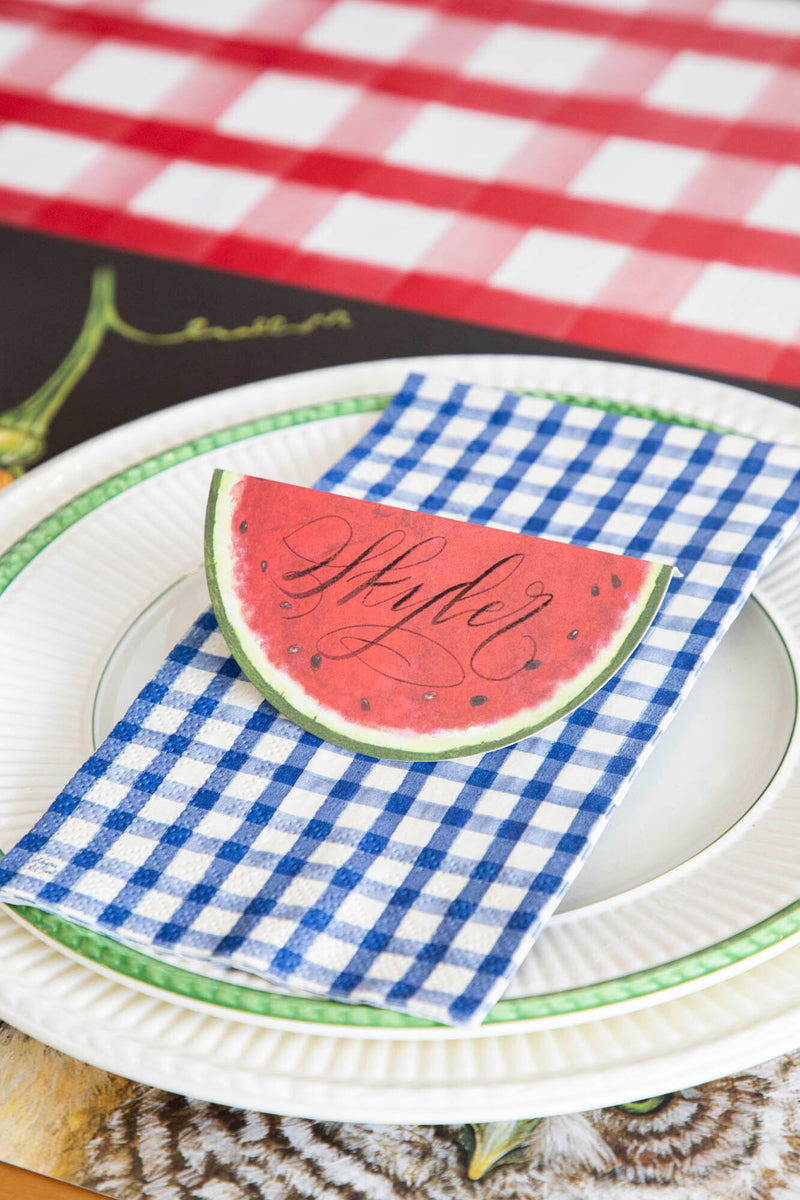 A Navy Painted Guest Napkin centered on the plate of a summertime place setting.