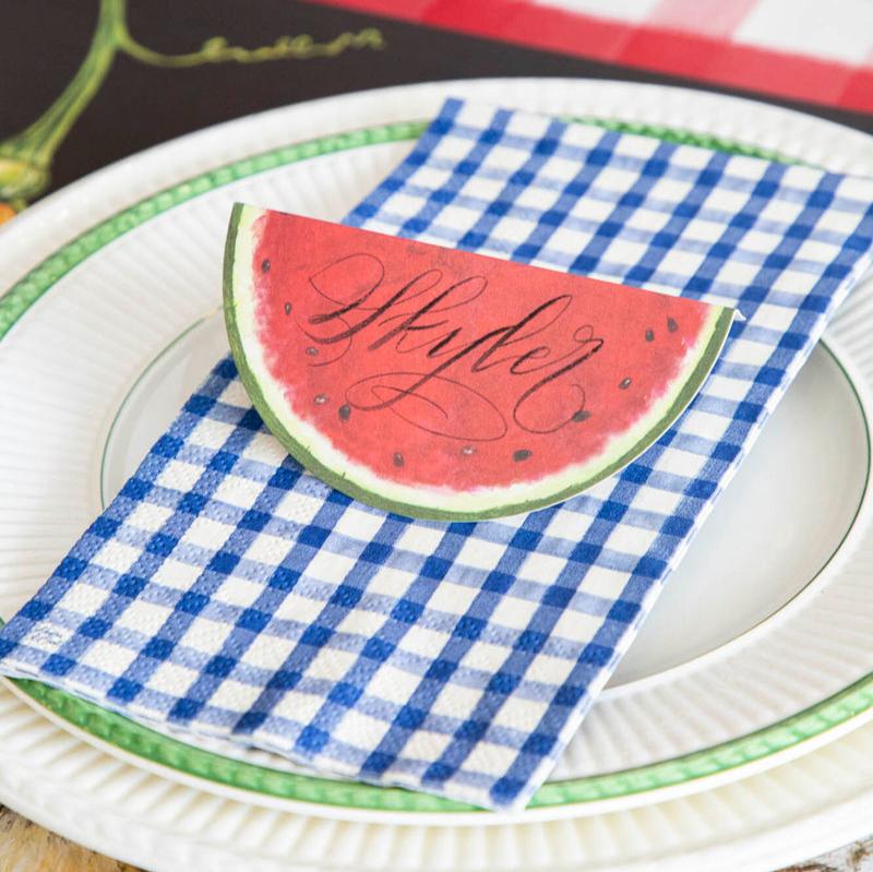 A Navy Painted Guest Napkin centered on the plate of a summertime place setting.
