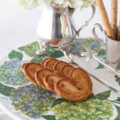 Close-up of a row of cookies and a flower vase on a Hydrangea Serving Paper.