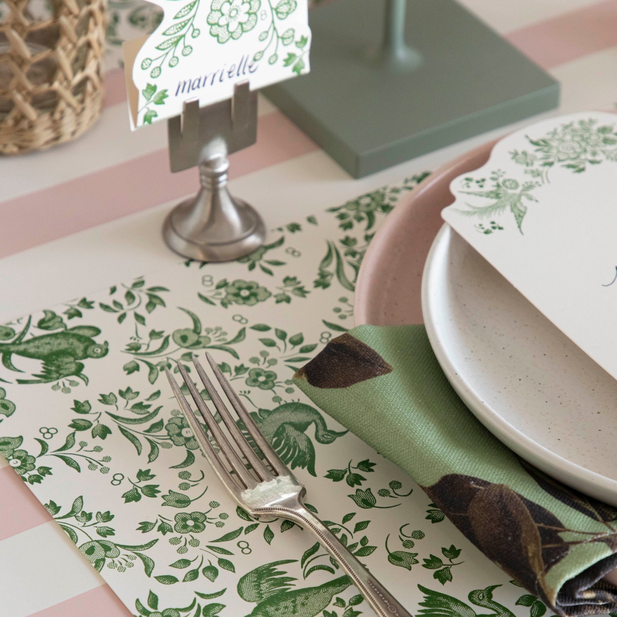 Close-up of the Green Regal Peacock Placemat under an elegant table setting, showing bird and flower details.