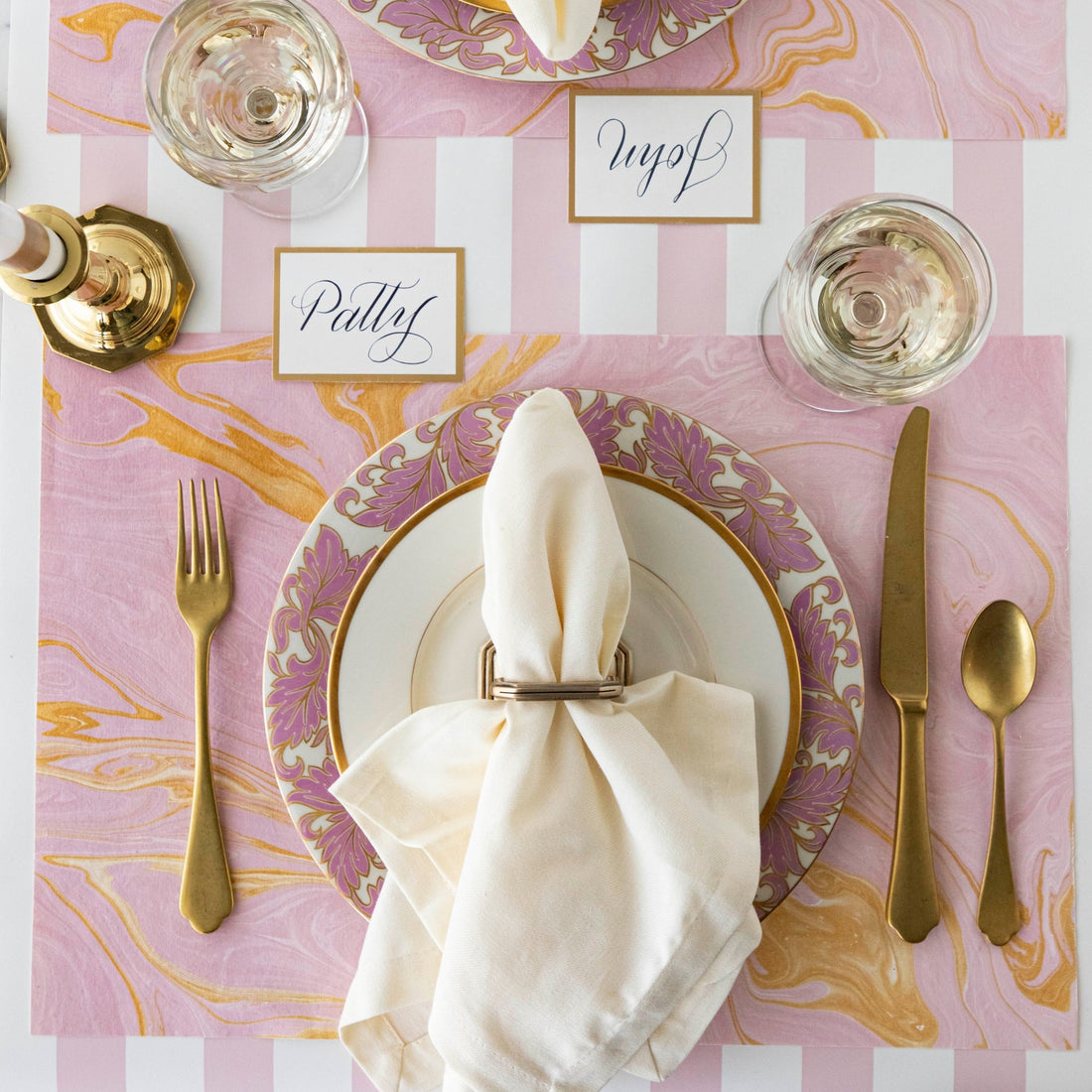 The Pink &amp; Gold Vein Marbled Placemat under an elegant place setting, from above.