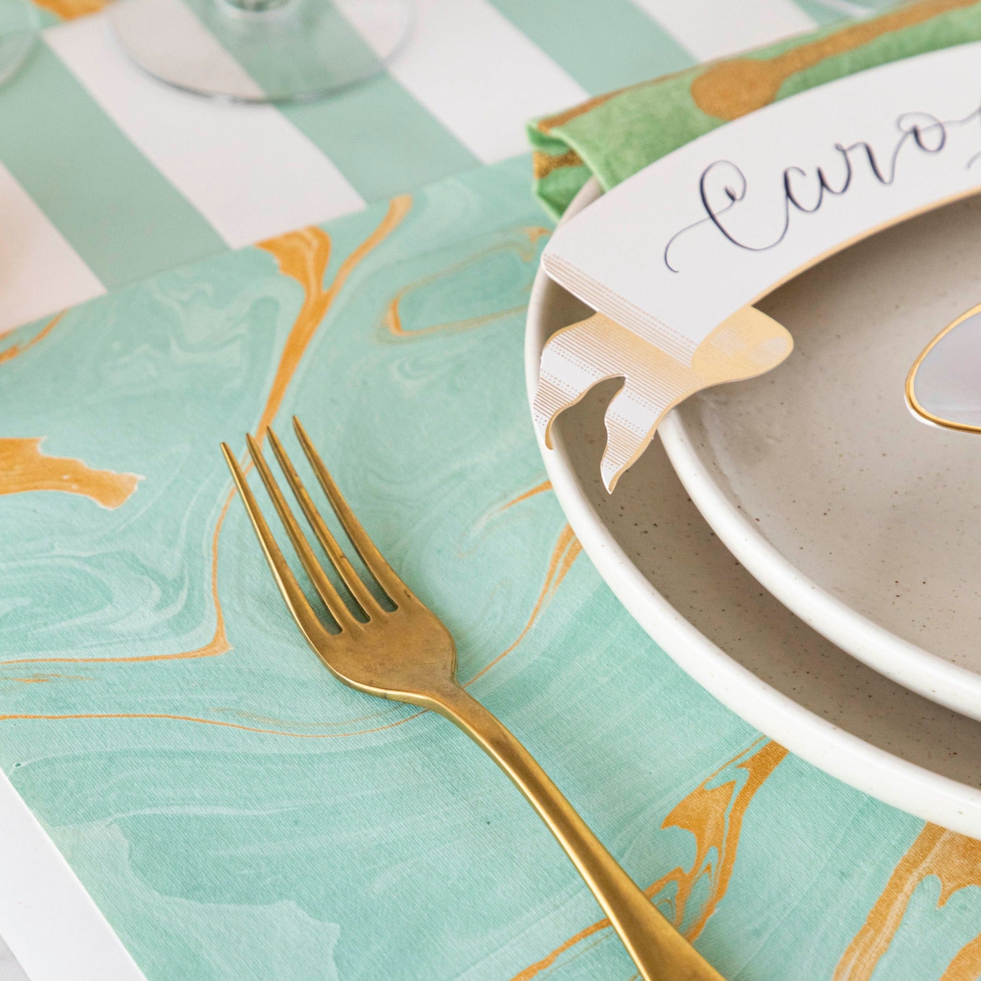Close-up of the Seafoam &amp; Gold Vein Marbled Placemat under an elegant place setting, showing the rich seafoam color swirled with gold.