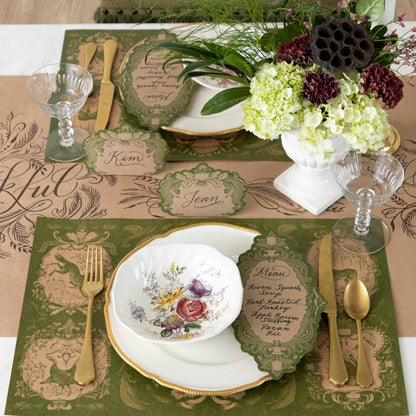 A Moss Fable Toile Table Card with a menu written on it in beautiful script resting on each plate of a rustic table setting.