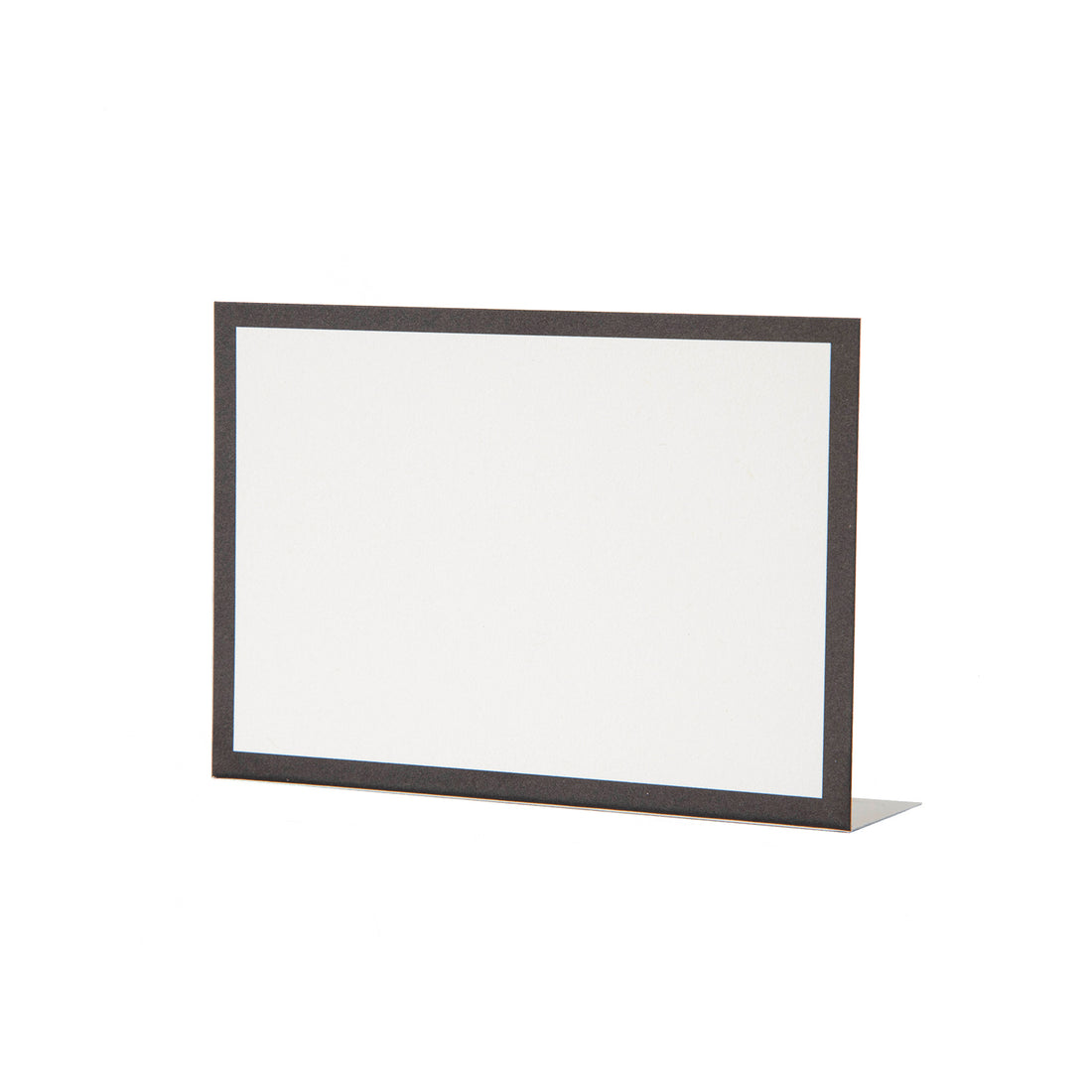 A free-standing, rectangular white table card with a simple black frame around the edges.