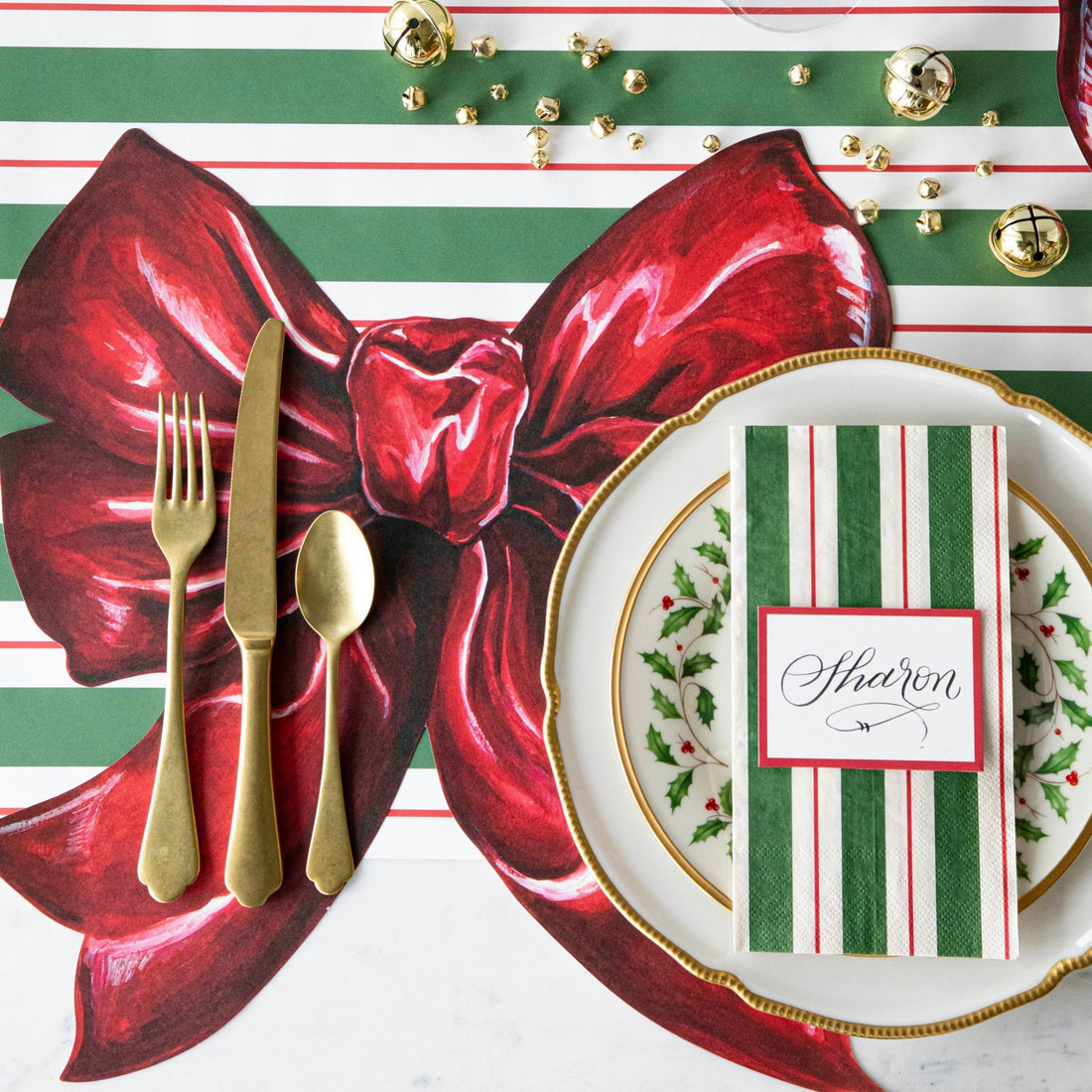 The Die-cut Bow Placemat under an elegant Christmas-themed place setting, from above.