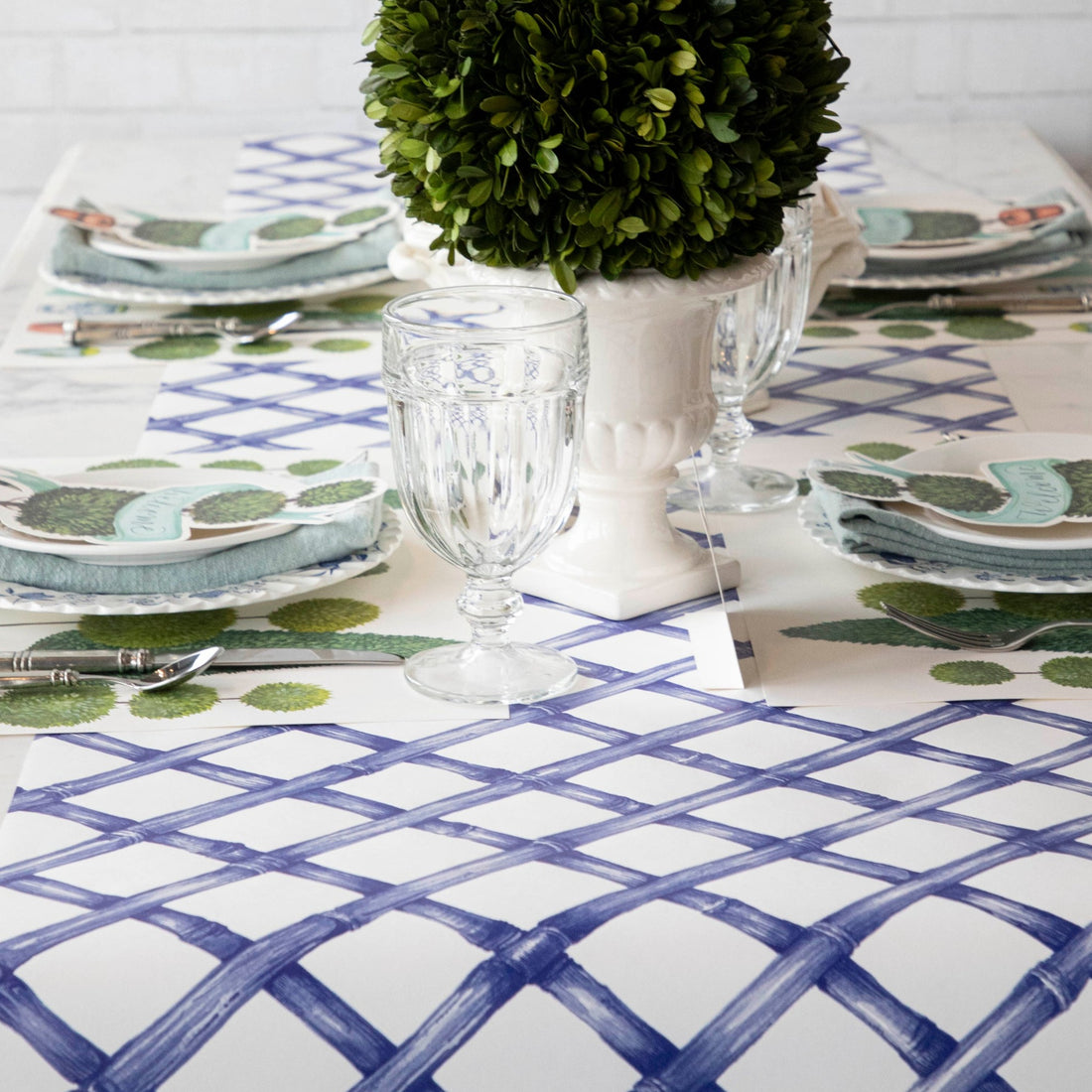 The Blue Lattice Runner under an elegant topiary-themed table setting.