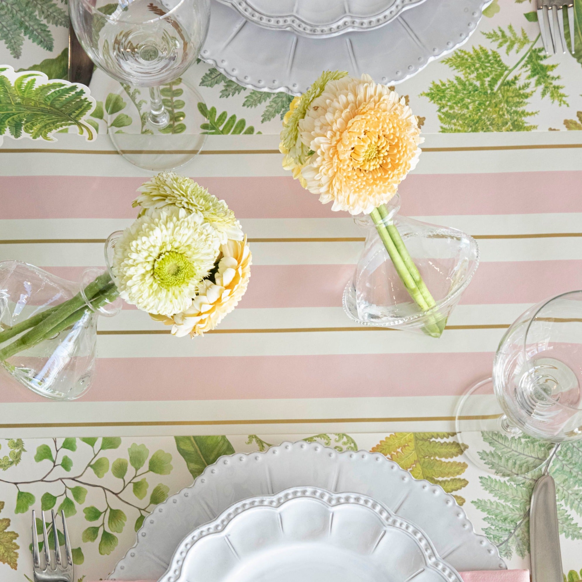 Close-up of the Pink &amp; Gold Awning Stripe Runner under an elegant springtime table setting, from above.