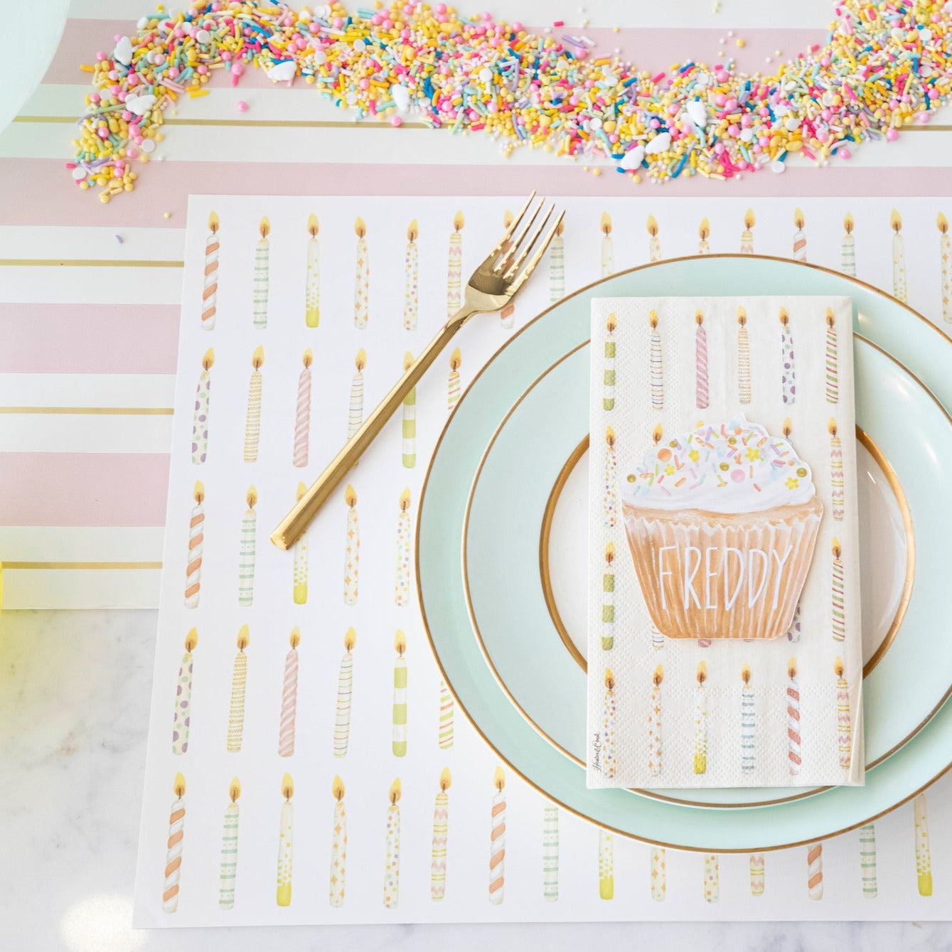 The Pink & Gold Awning Stripe Runner under an elegant birthday place setting.