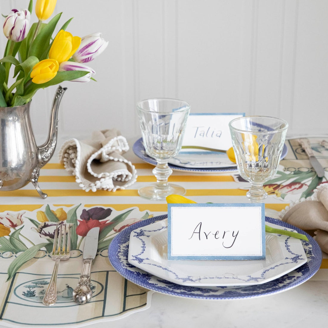 A table setting with a Cornflower Blue Place Card and tulips from Hester &amp; Cook.