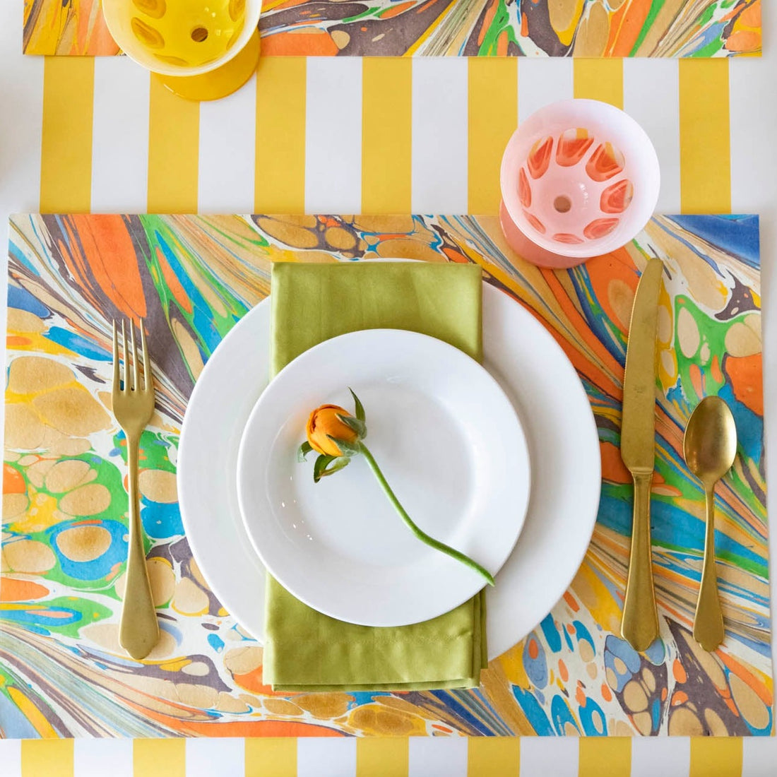 The Multi Color Fantasy Marbled Placemat under a vibrant place setting, from above.