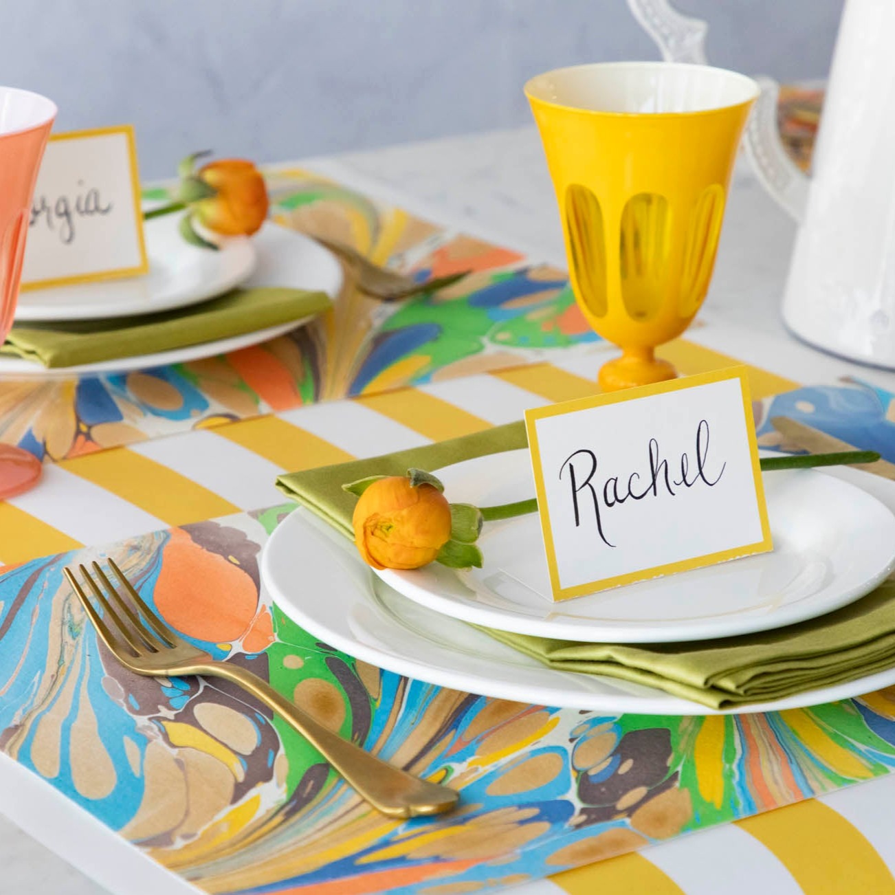 The Multi Color Fantasy Marbled Placemat under a vibrant table setting.