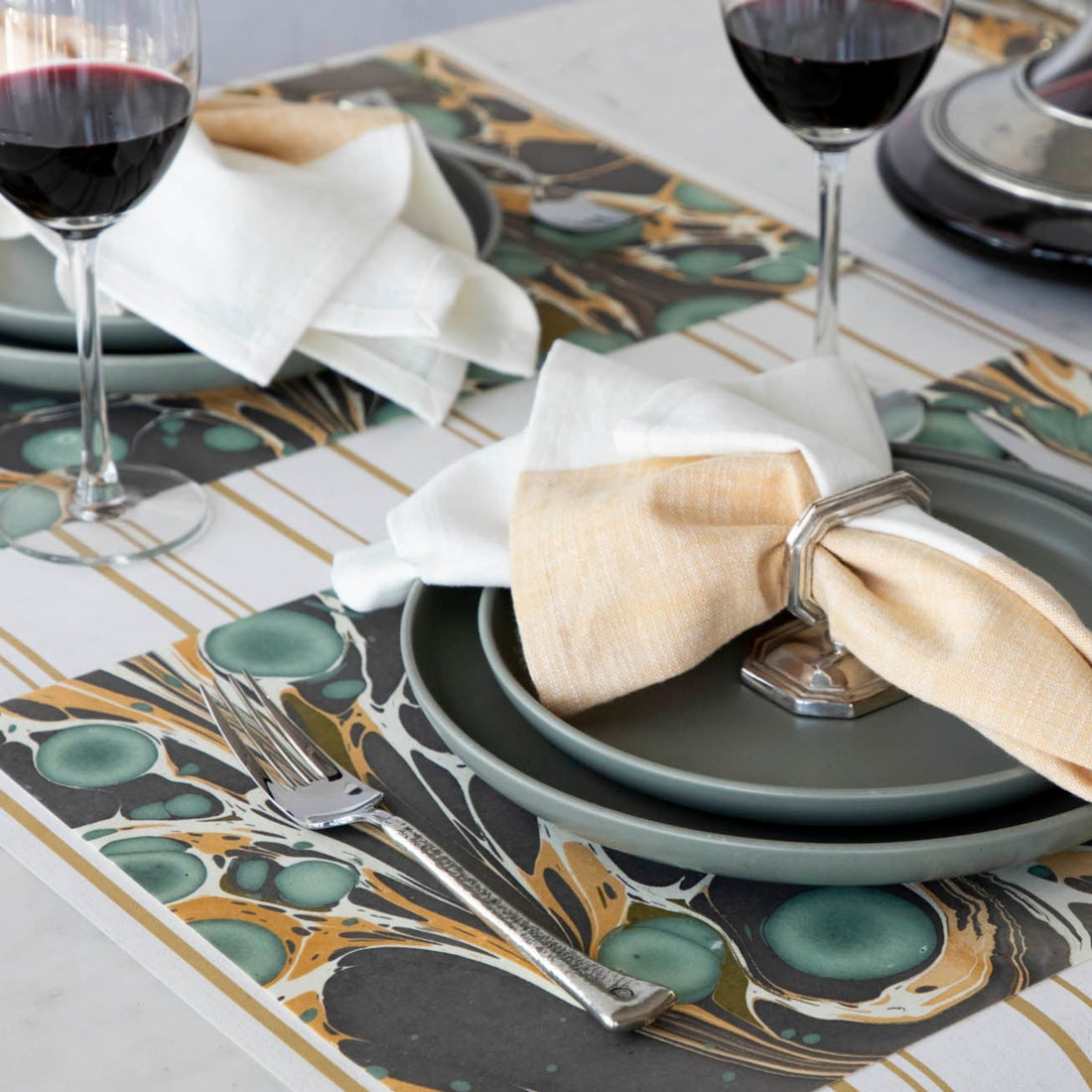 The Brown Stone Marbled Placemat under an elegant table setting.