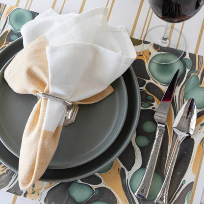 Close-up of the Brown Stone Marbled Placemat under an elegant place setting.