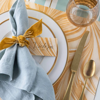 Close-up of the Gold Leaf Marbled Placemat under an elegant place setting.