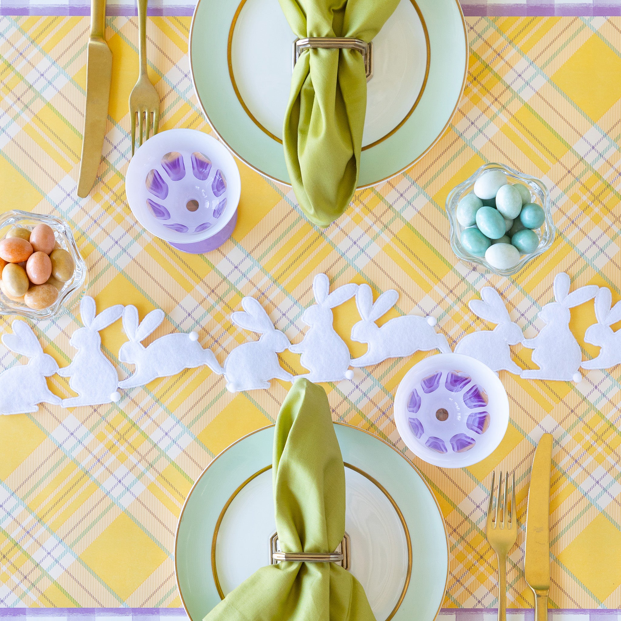 Rabbit Garland Ribbon with white appliqué rabbits made of felt running down a table with a yellow plaid runner and purple glasses on it.