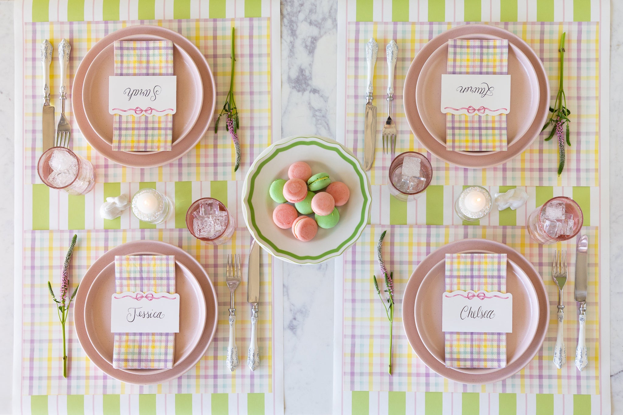 Set table with pink plates, Spring Plaid Placemats and Guest Napkins, Pink Bow Place Cards and decorative elements on the Green & Pink Awning Stripe Runner.