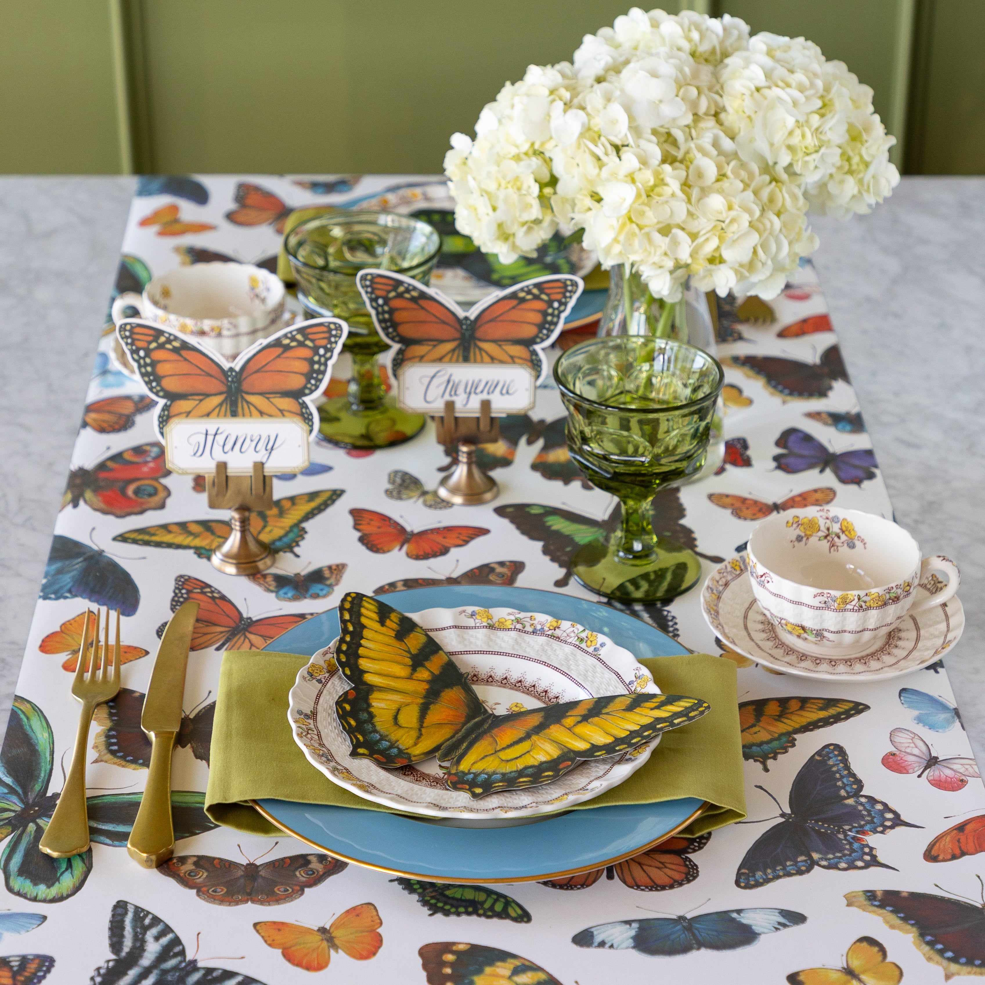 Butterfly-themed table setting with flowers, Die-cut Butterfly Placemats, Butterfly Table Accents and colorful dinnerware on the Butterflies Runner.