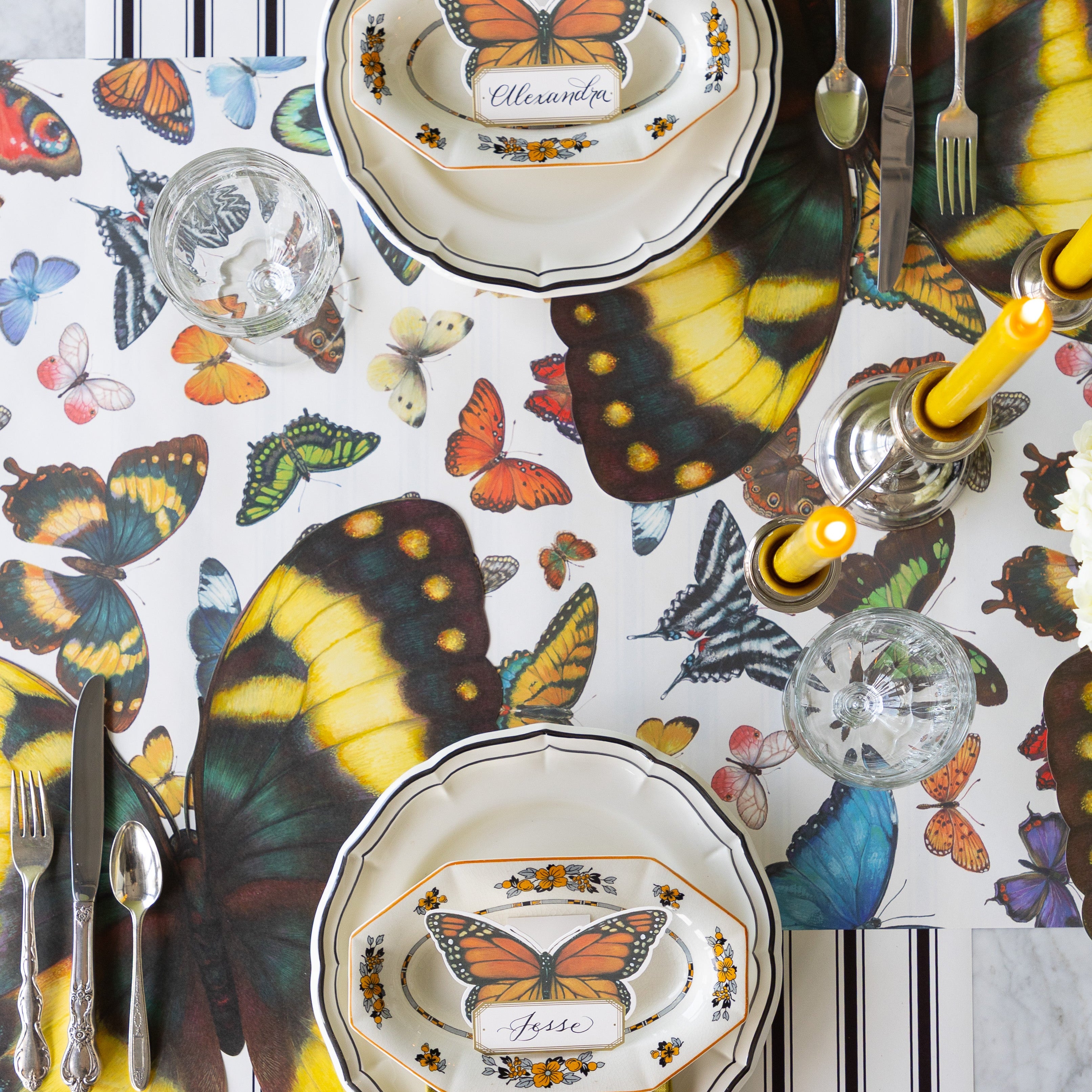 Butterfly-themed table setting with Die-cut Butterfly Placemats, Butterfly Place Card and Black Icing on the Cake plates on the Butterflies and Black Linen Stripe Runners.
