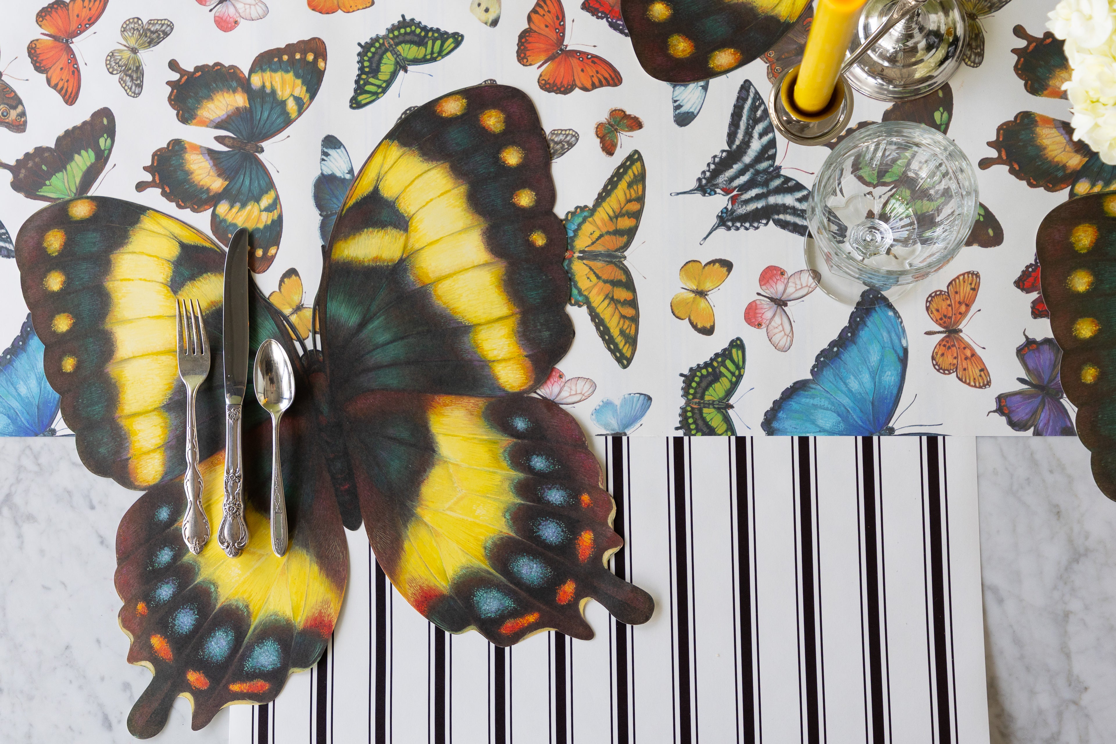 Die-cut Butterfly Placemat with vintage silverware and a glass on the Butterflies and Black Linen Stripe Runners.