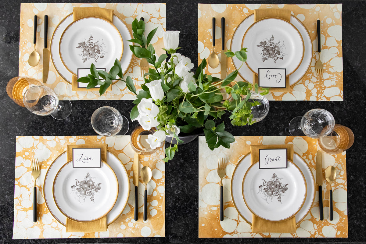 The Gold Stone Marbled Placemat used in an elegant table setting for four, from above.