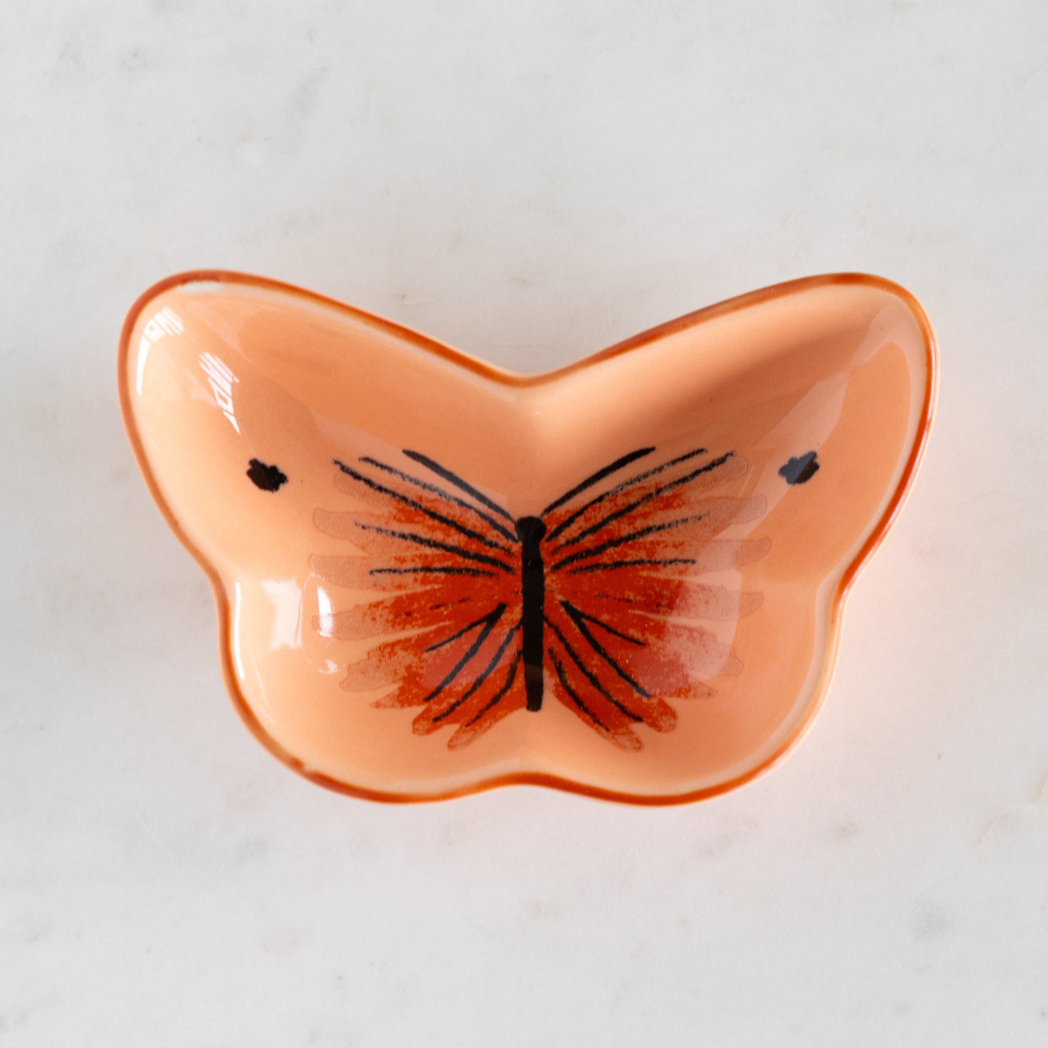 Butterfly-shaped dish with a butterfly design on a light background.
