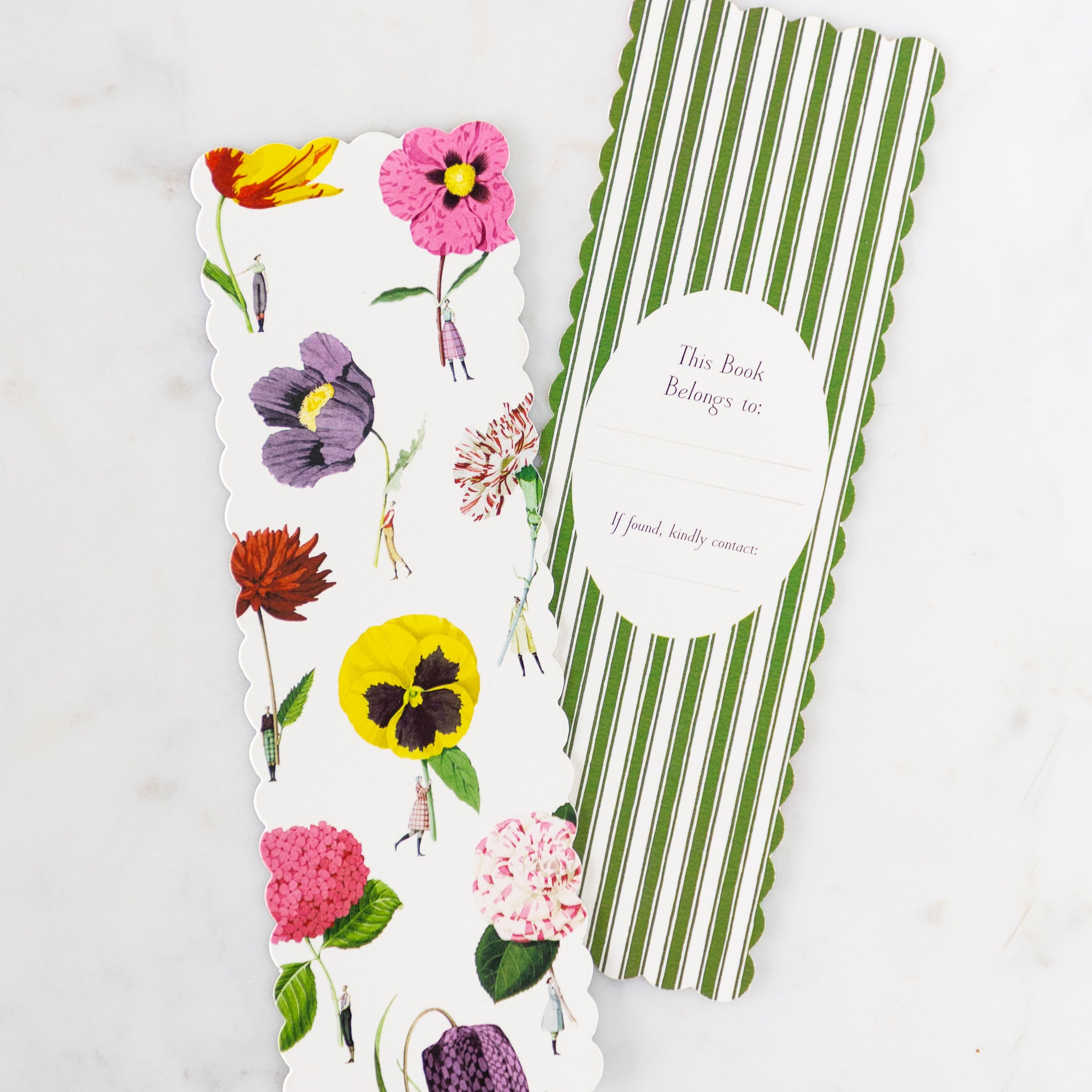 Two Botanical Bookmarks with scalloped edges––the front showing various flowers held by tiny people while the back features green stripes with an oval for owner details.