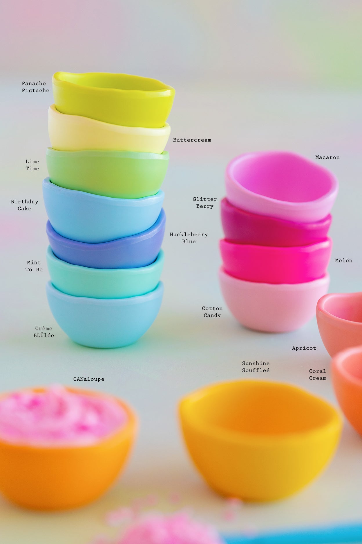 A set of colorful, dishwasher-safe Glitterville Rainbow Melamine Trinket Bowls on a table.