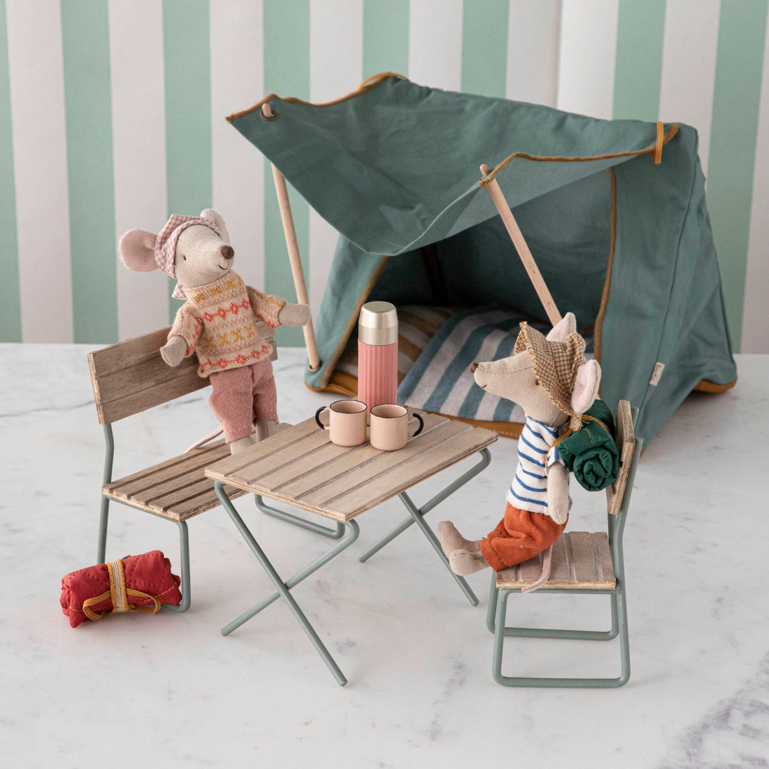 Two Mini Garden Sets from Maileg, each featuring stuffed toy mice dressed in clothes and simulating a camping scene with miniature camping equipment made from FSC certified wood.