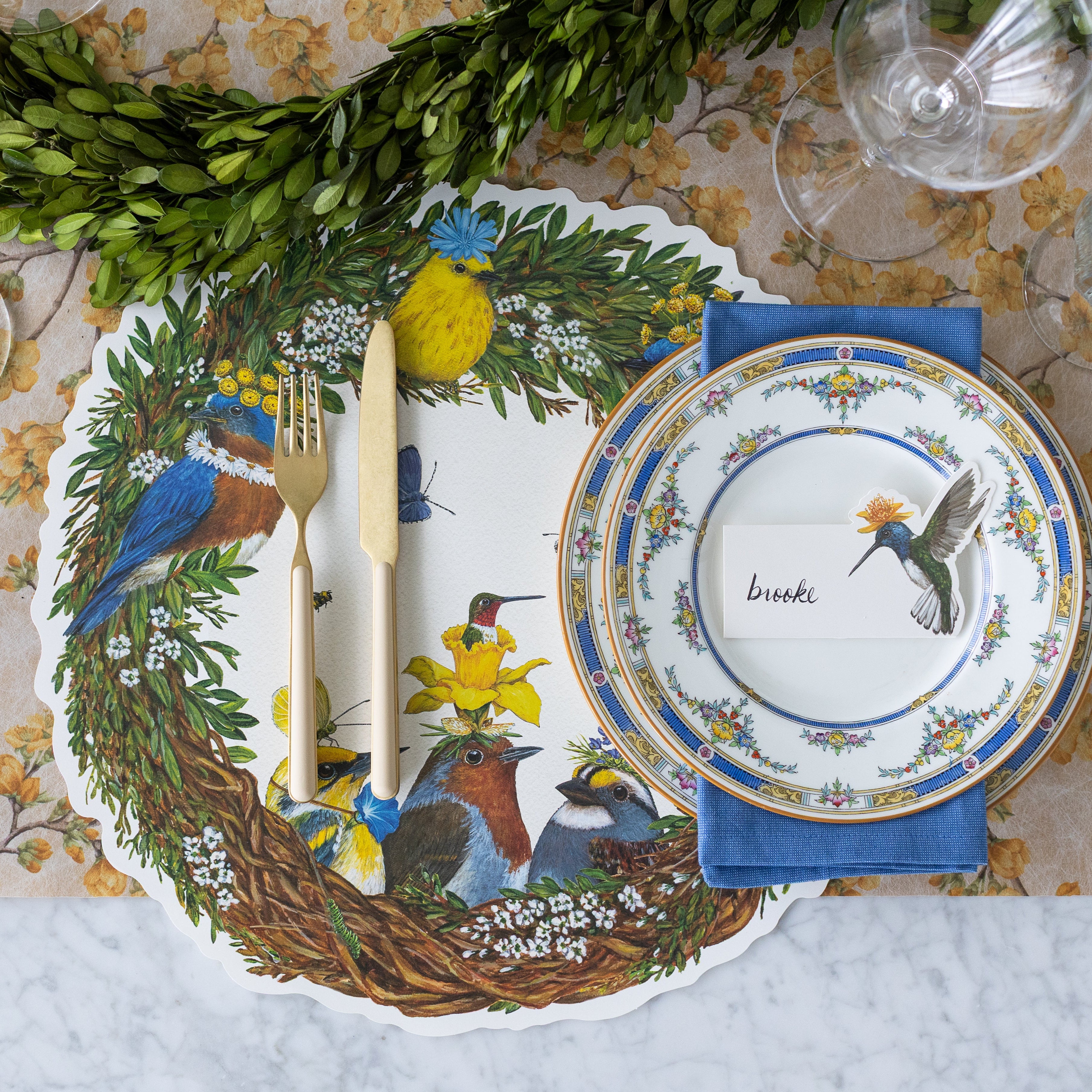 A place setting with the Die-cut Songbird Wreath on the Marigold Cherry Blossom Runner.
