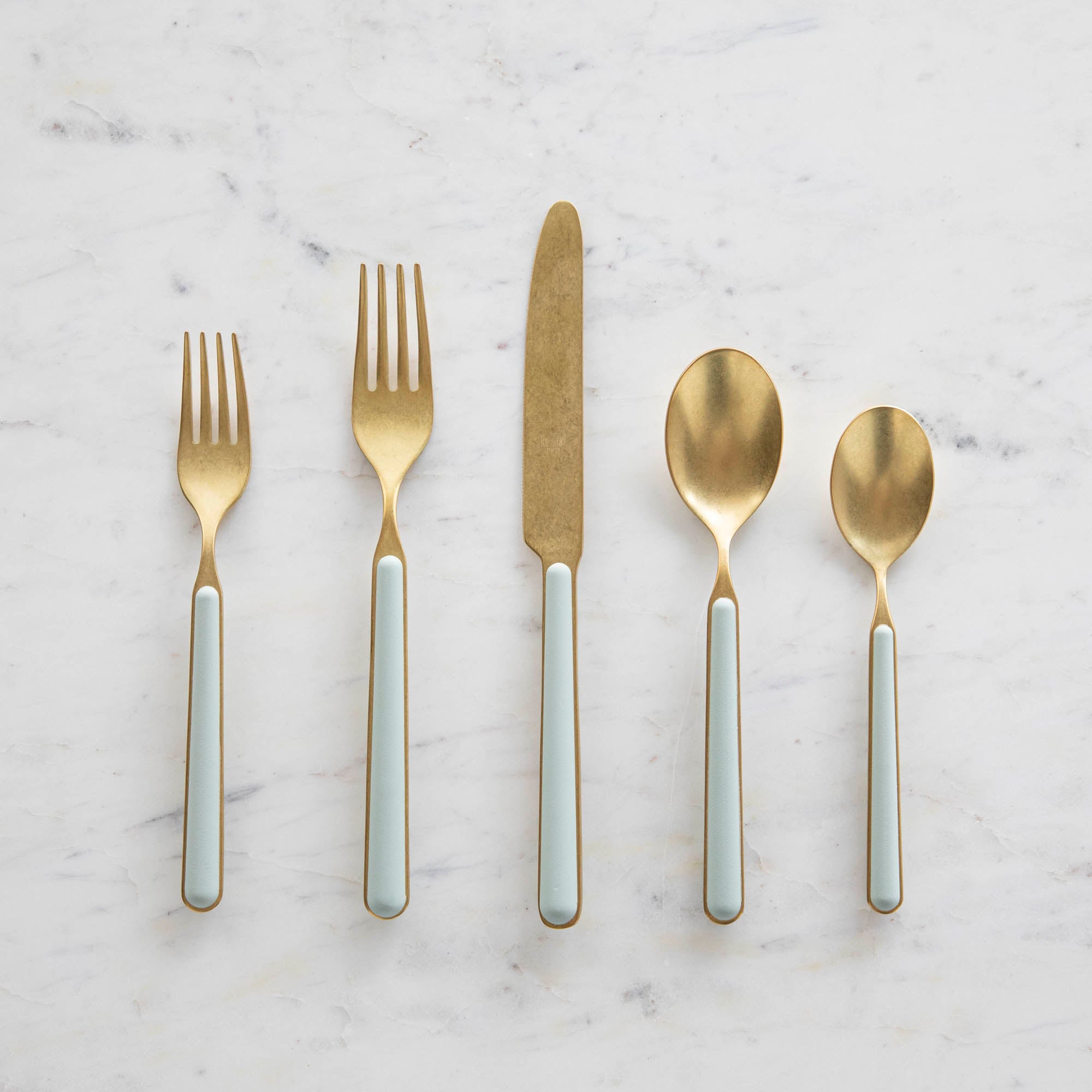 Fantasia Sage 5-Piece Place Setting by Mepra arranged on a marble surface.