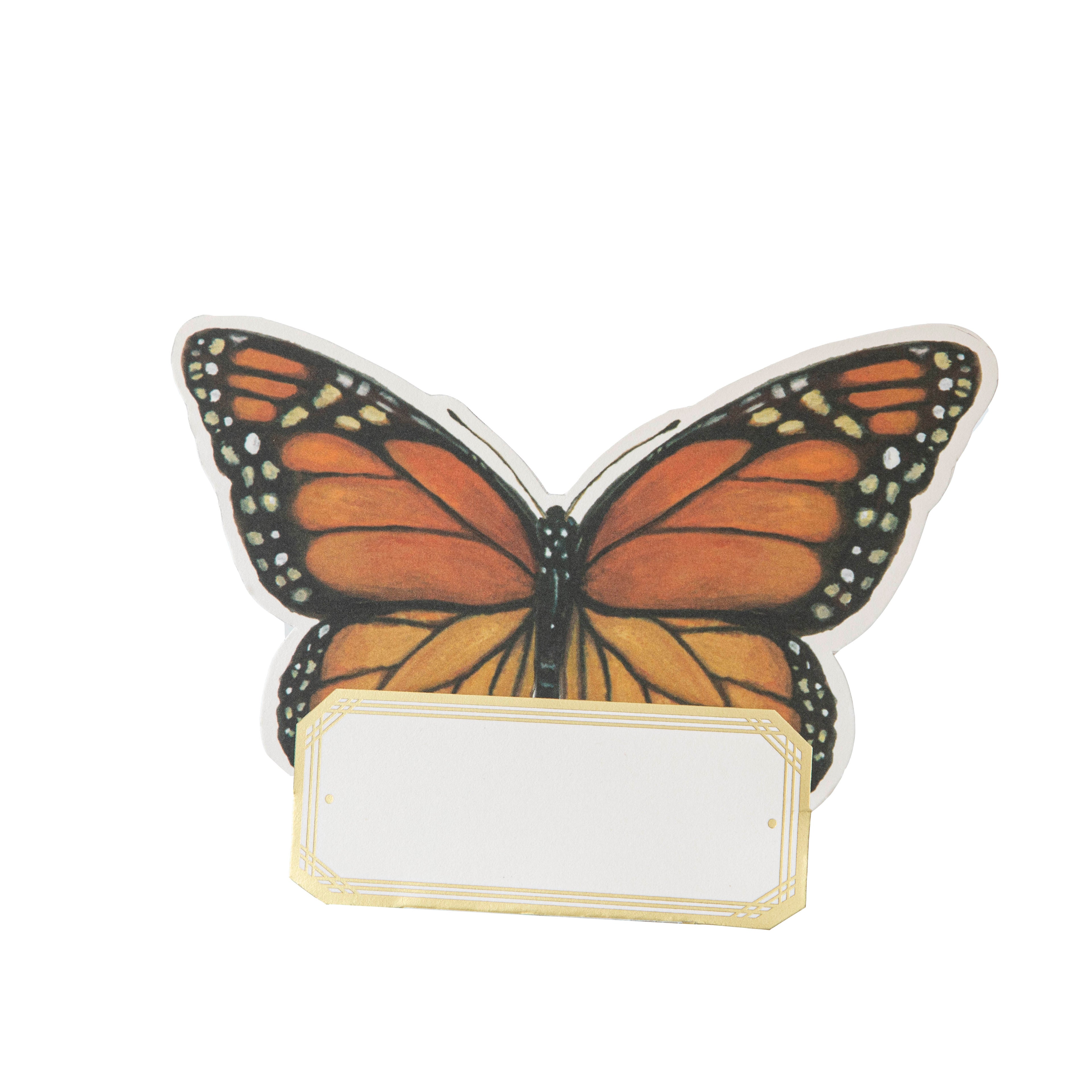 A die-cut freestanding place card featuring a gorgeous illustration of a monarch butterfly at the top, and a gold-framed open white rectangle at the bottom for personalization.