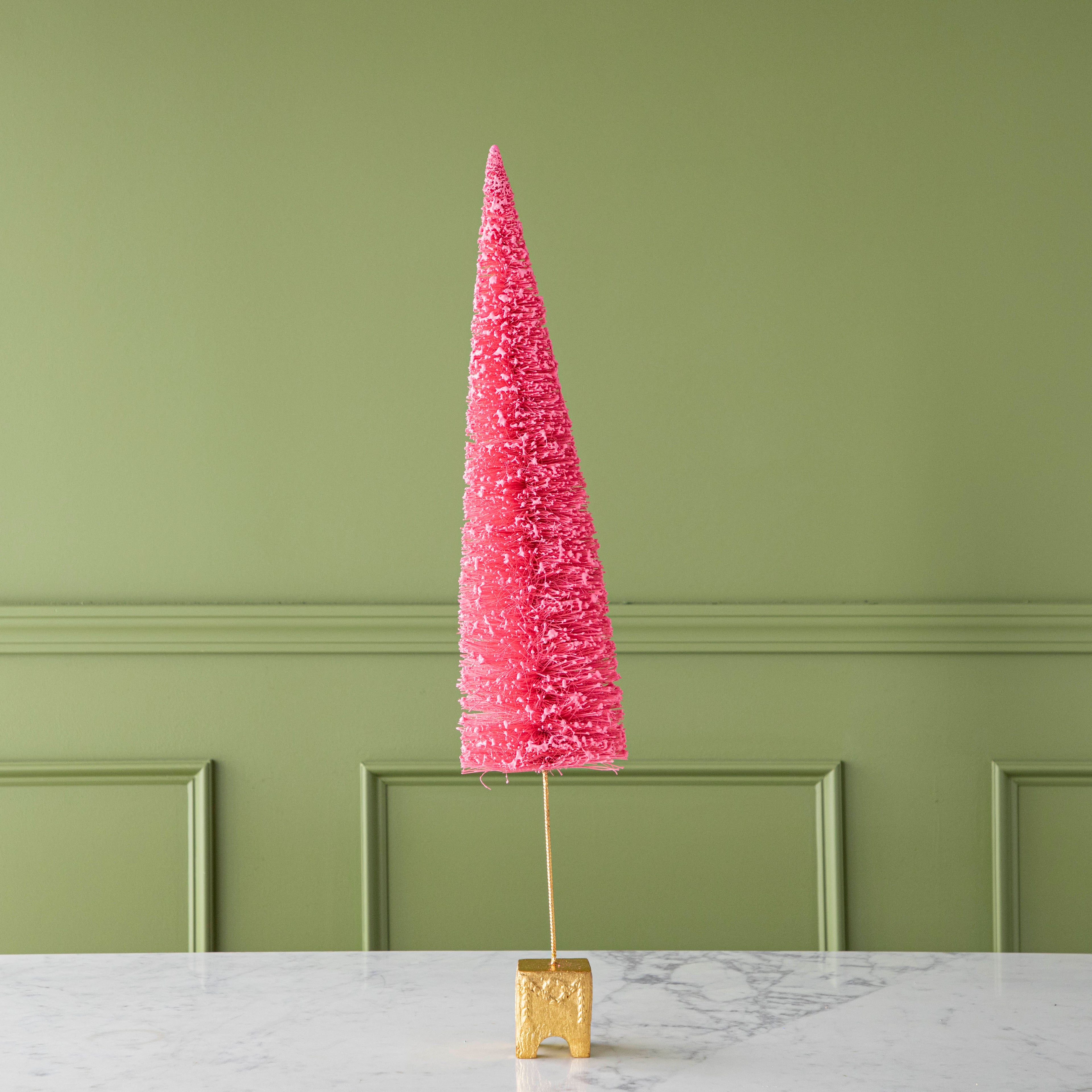 A 29" Coral French Forest Sisal Tree with a gold base, on a marble table.