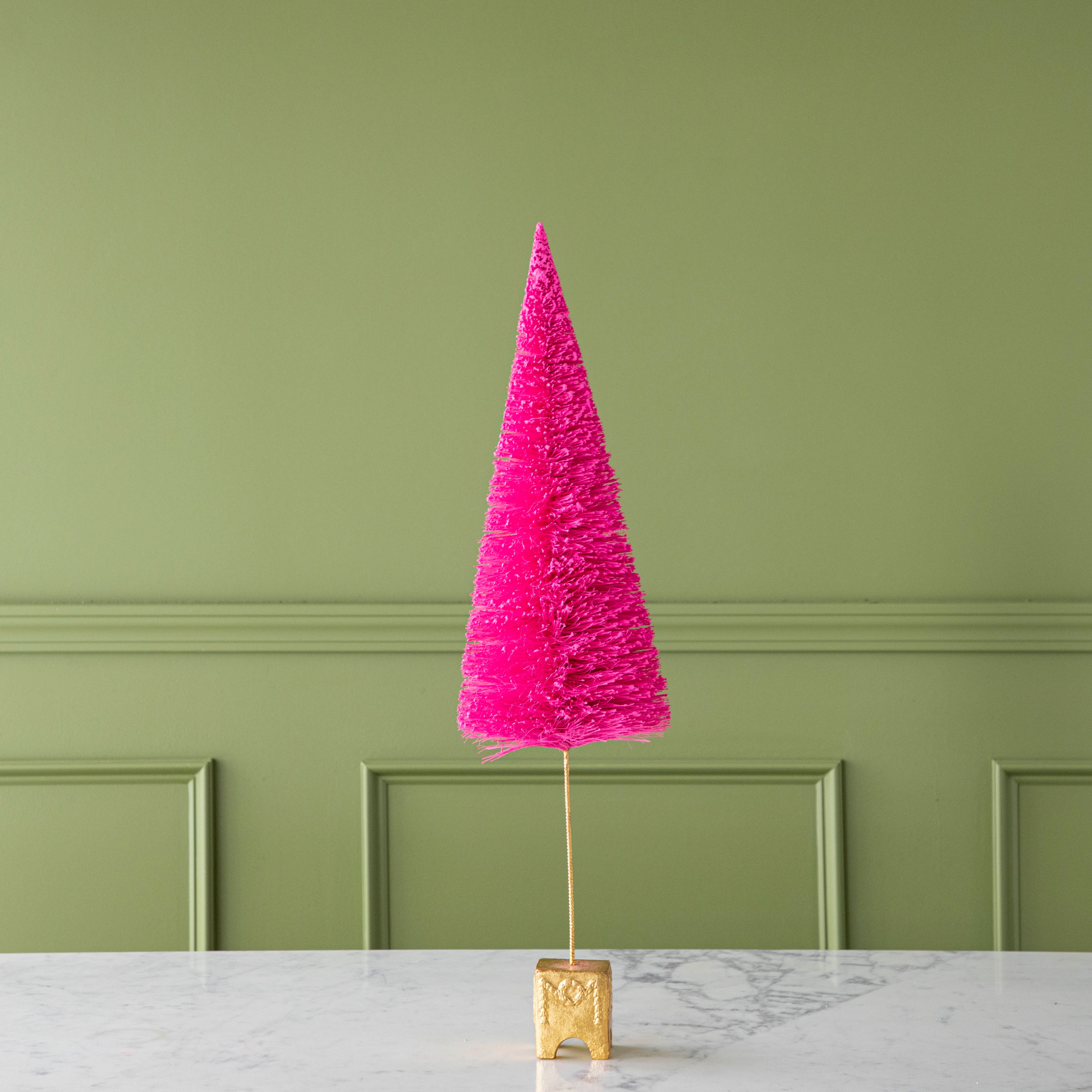 A 26" Hot Pink French Forest Sisal Tree with a gold base, on a marble table.