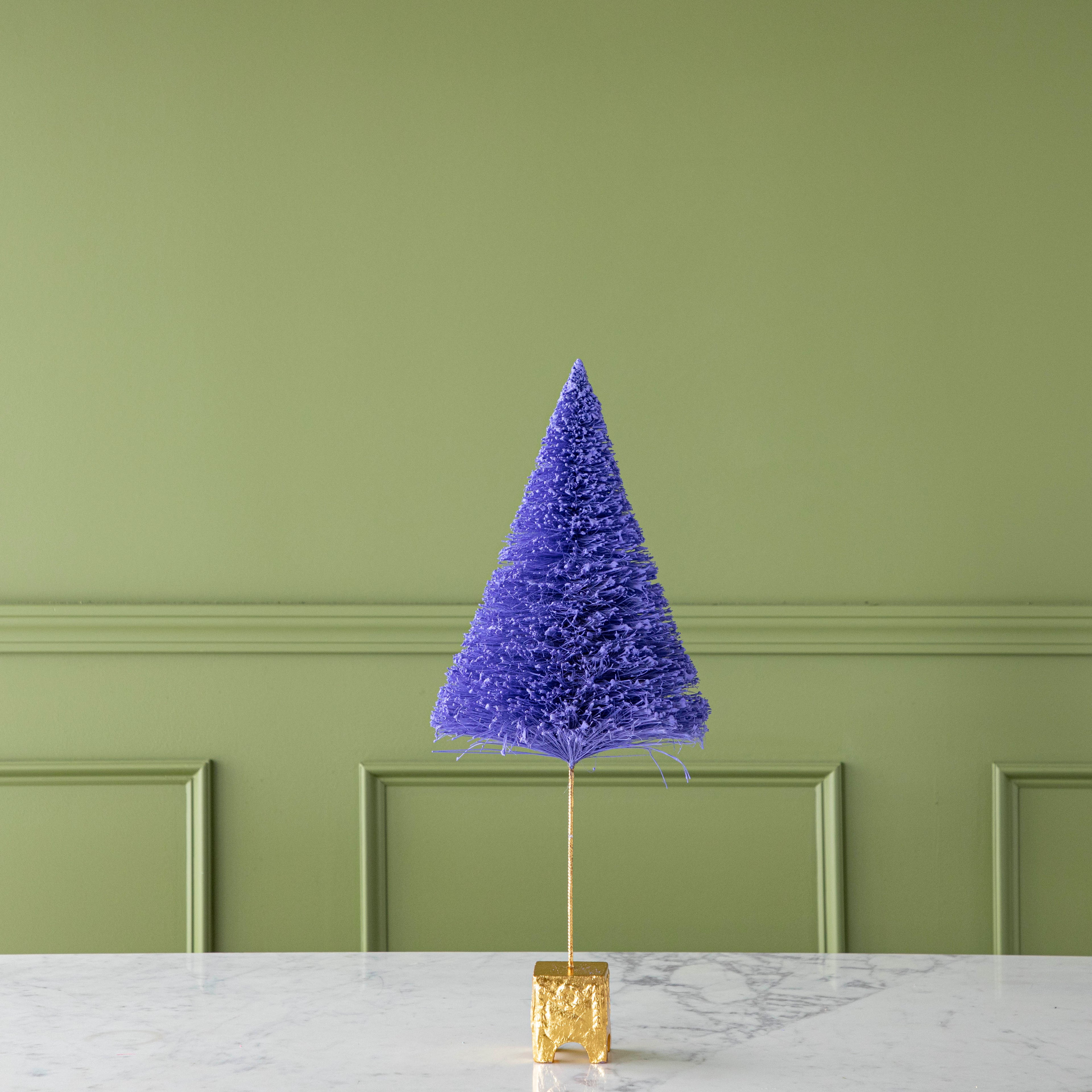 A 22" Ultra Violet French Forest Sisal Tree with a gold base, on a marble table.
