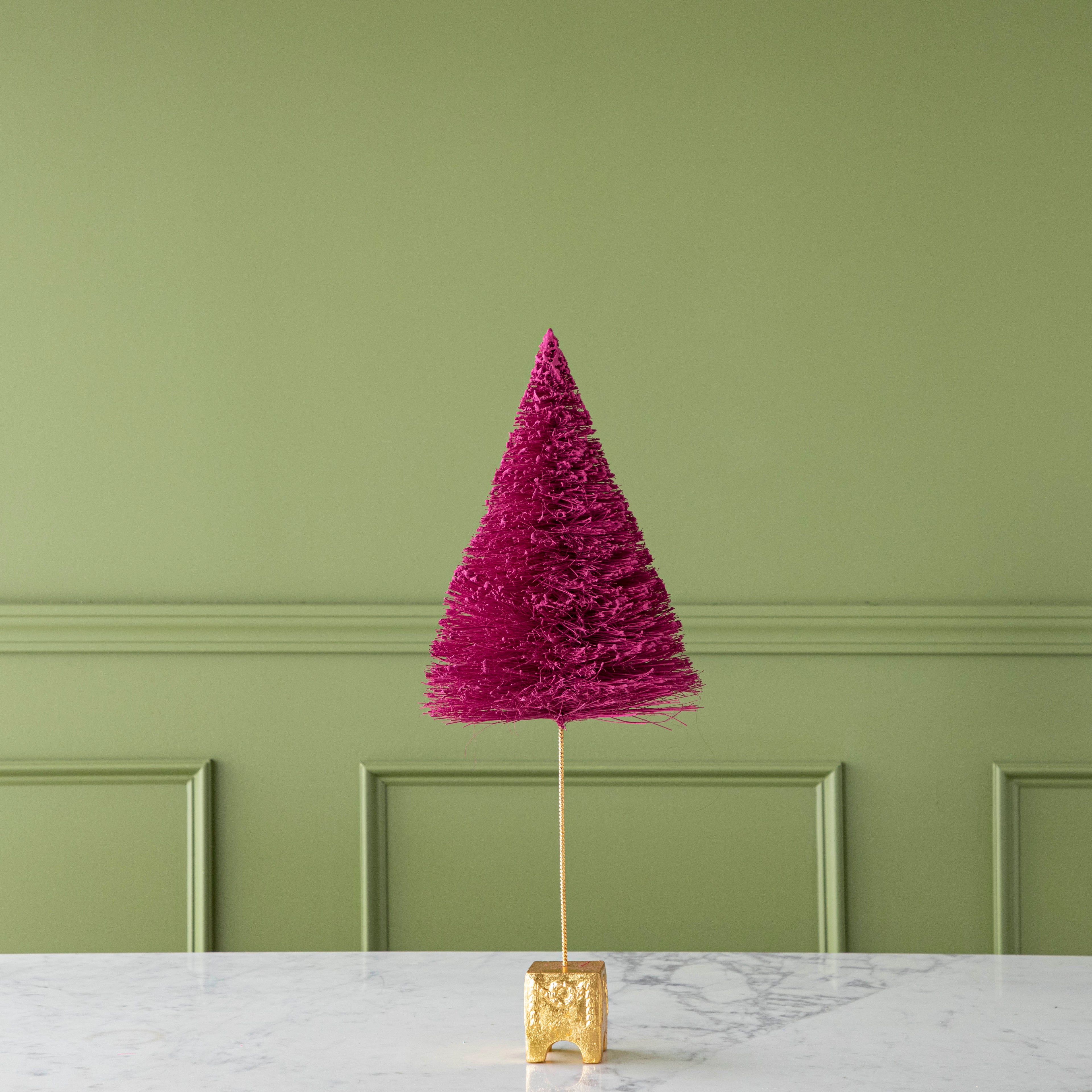 A 22" Magenta French Forest Sisal Tree with a gold base, on a marble table.