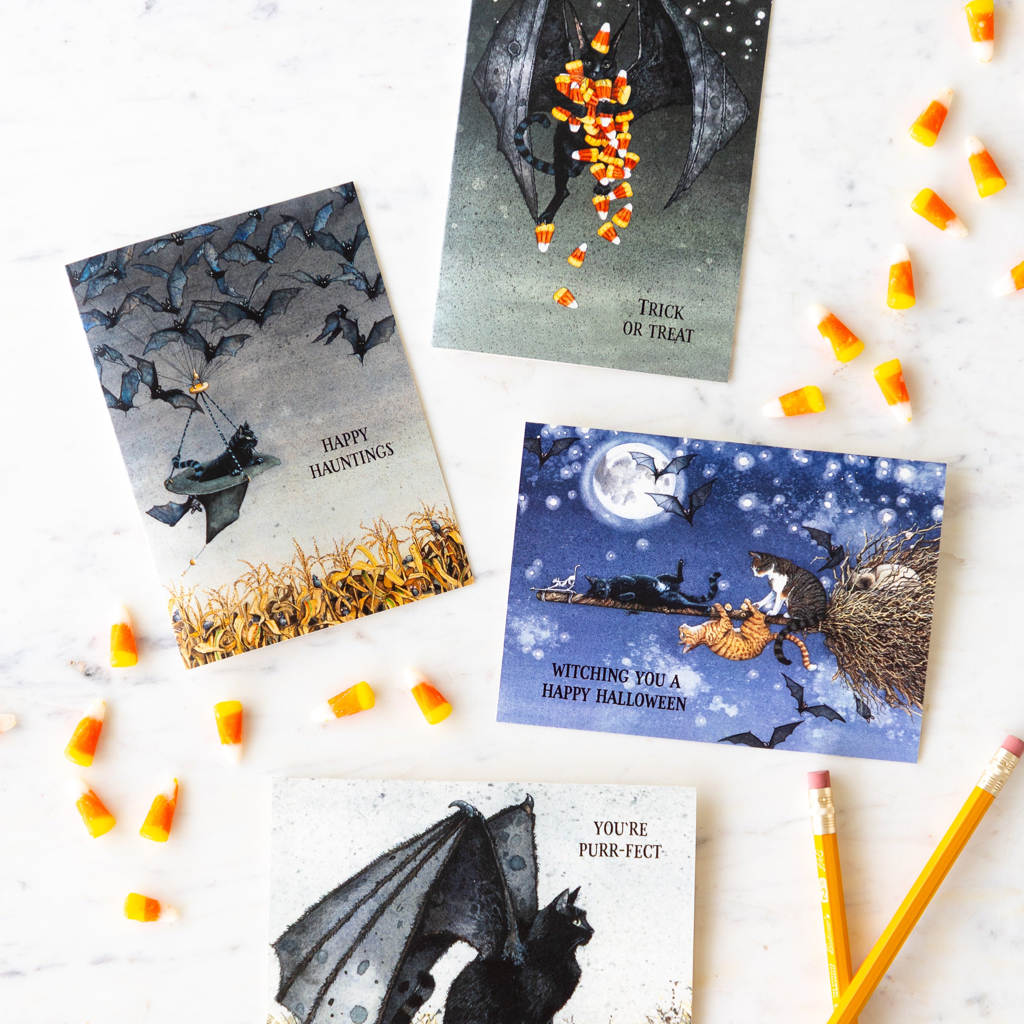 Maggie Vanderwalle halloween cards arranged on a table with scattered candy corn and two pencils.