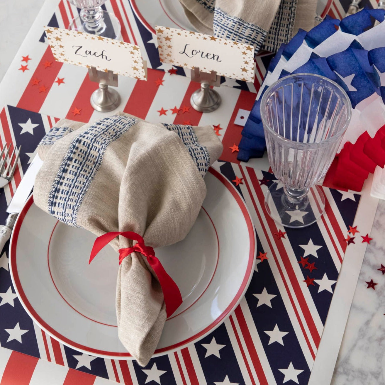 The Stars and Stripes Placemat under a patriotic place setting, from above. 
