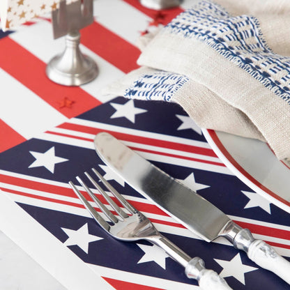 Close-up of the Stars and Stripes Placemat under a patriotic place setting, showing the striped design in detail.
