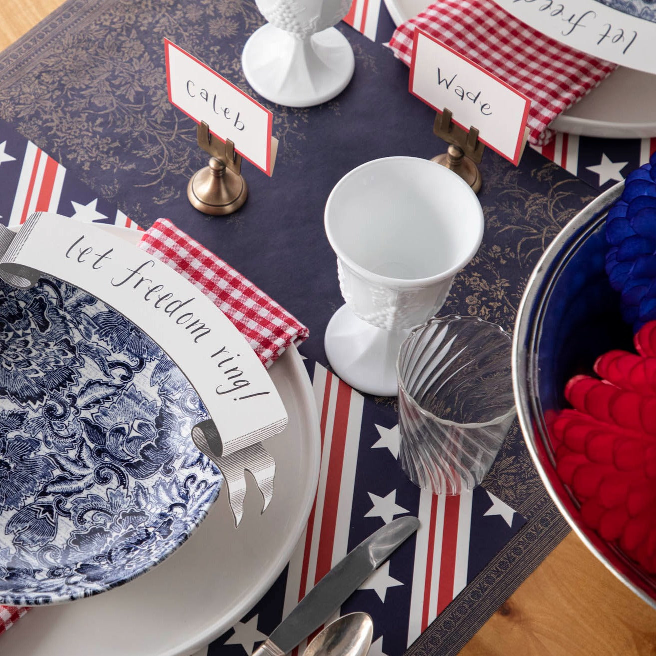 The Stars and Stripes Placemat under a patriotic table setting for two, from above.